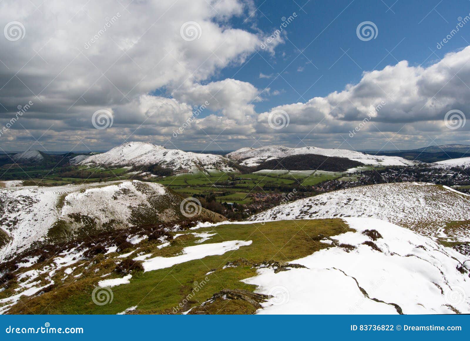 hill of the long mynd, view on the carding mill valley and caer caradoc, peaks under the snow, spring in the shropshire hills