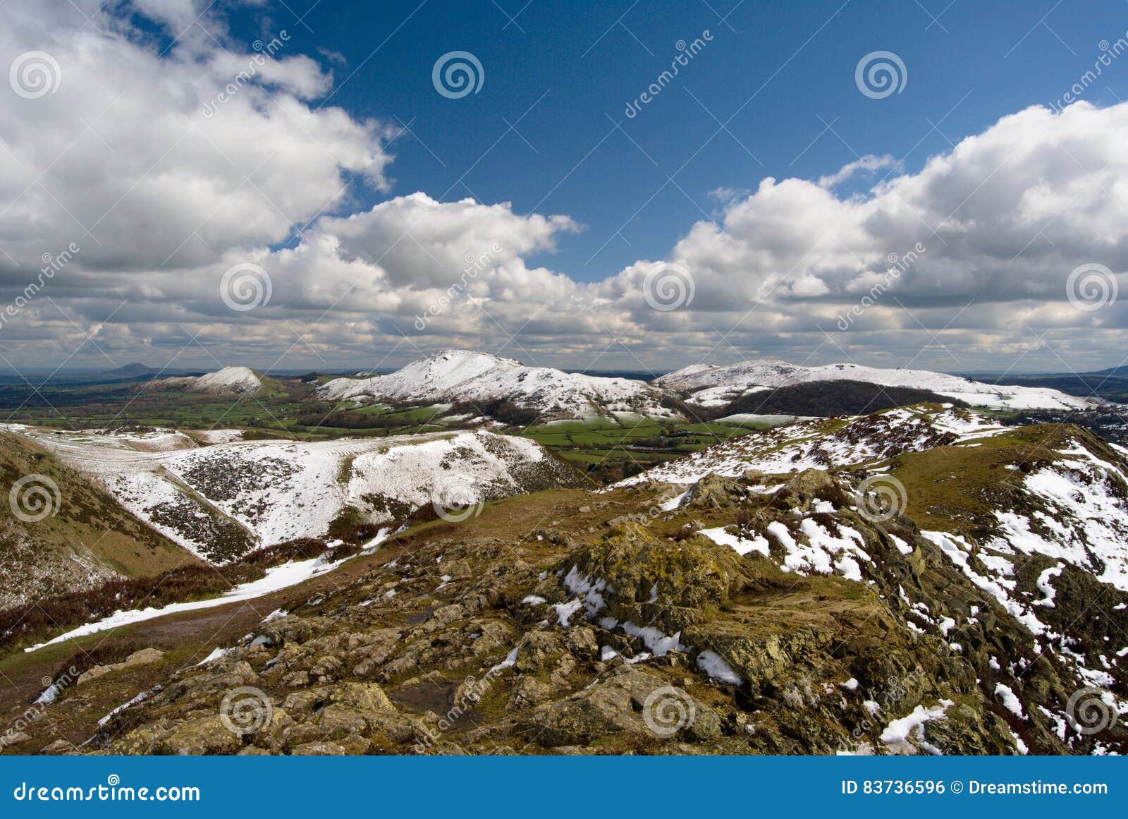 hill of the long mynd, view on the carding mill valley and caer caradoc, rocks in foreground, shropshire hills uk