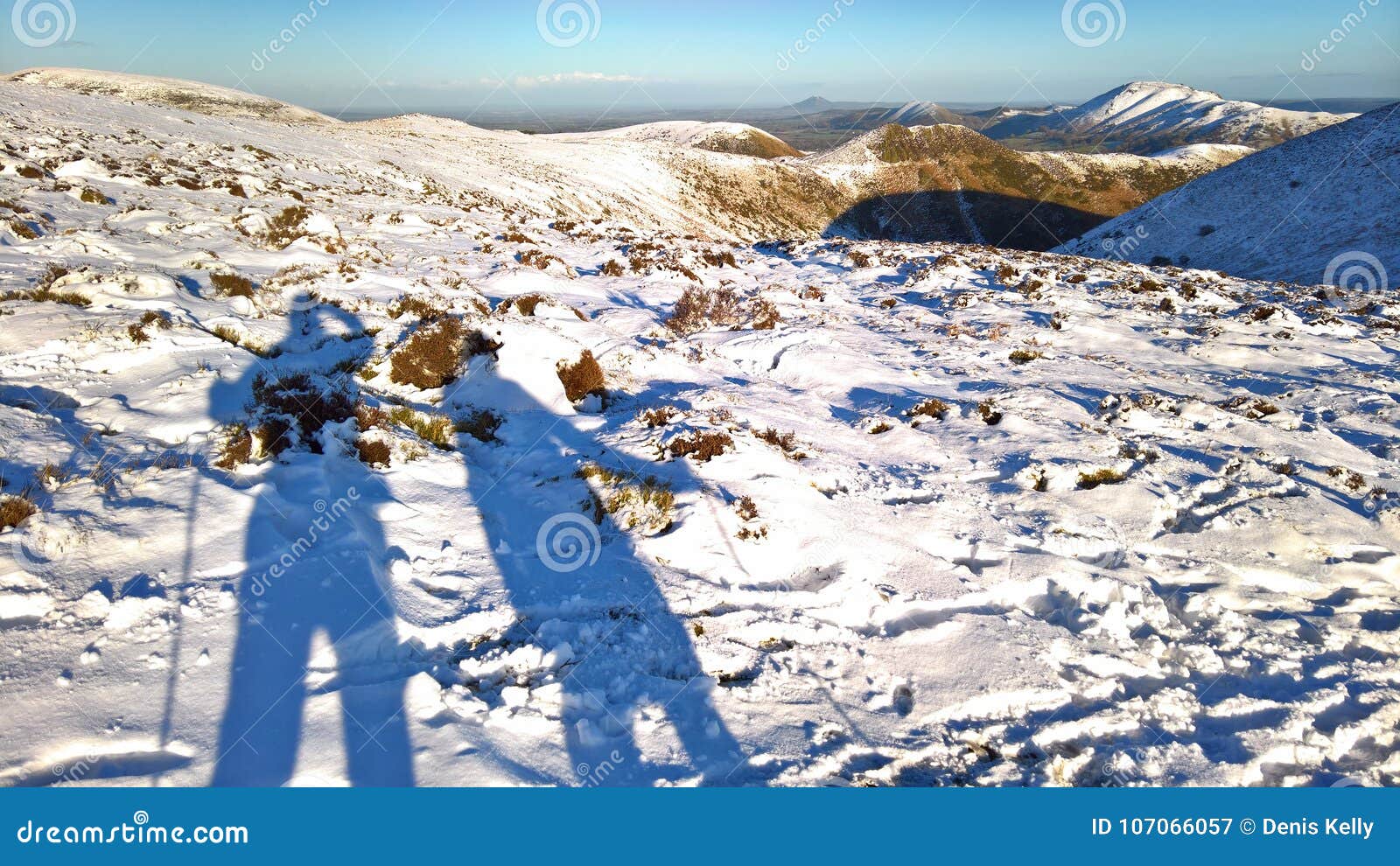 hill walkers in winter snow in england