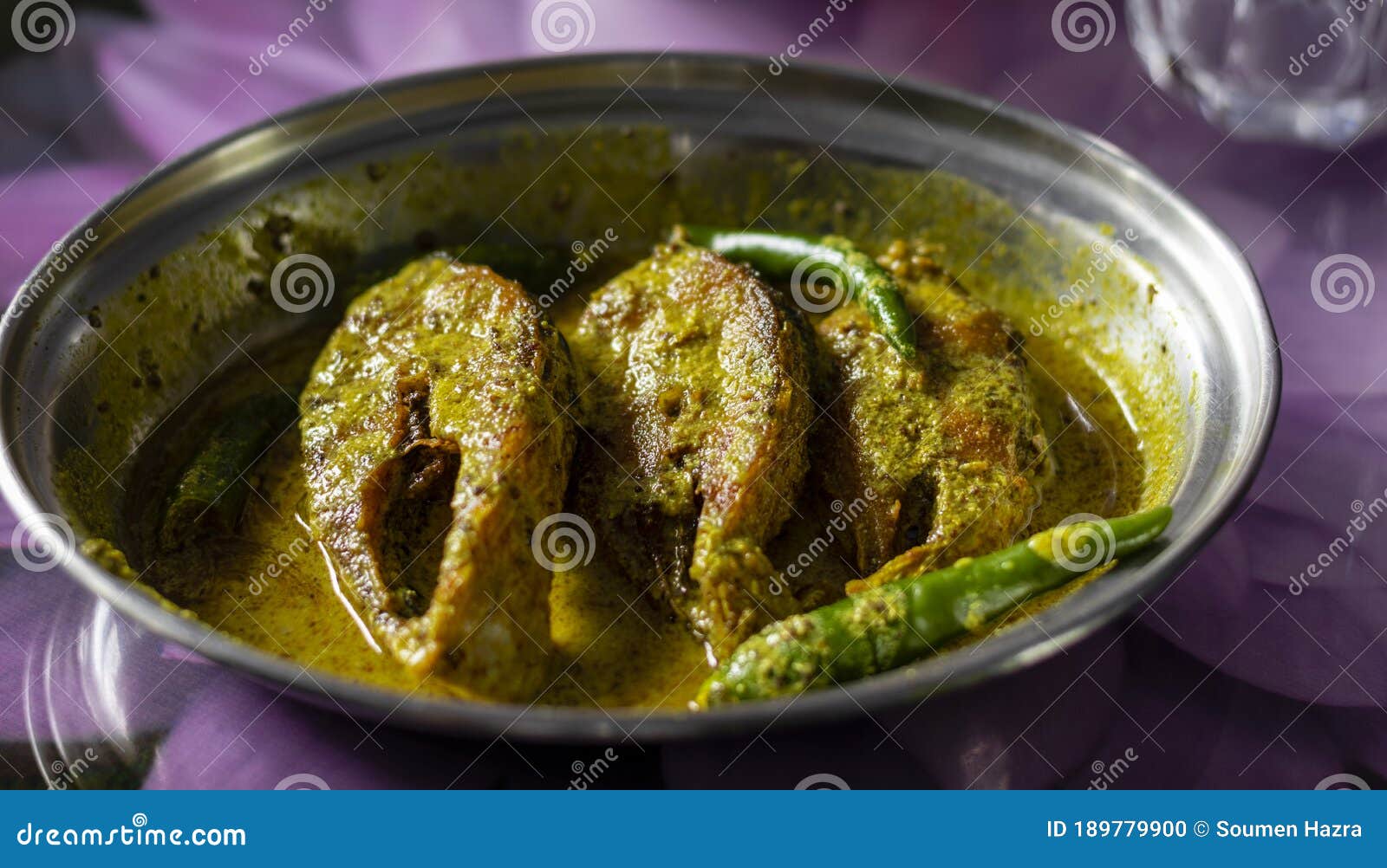 hilsa fish curry with mustard paste and green chilli served on plate with selective focus