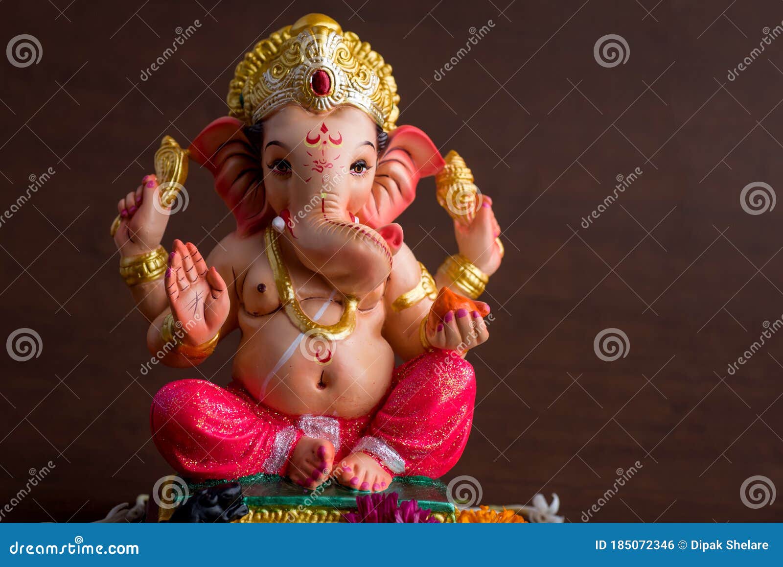 Hindu God Ganesha. Ganesha Idol On Dark Wooden Background Stock Photo  185072346 - Megapixl
