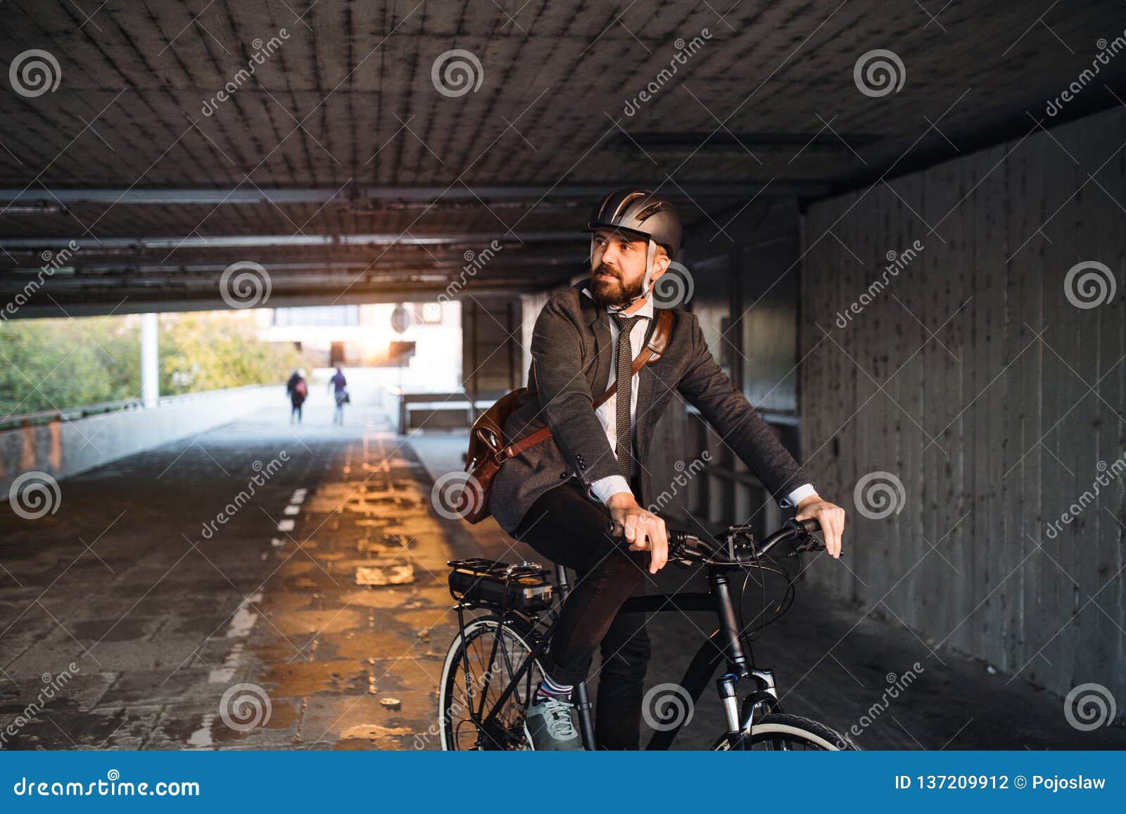 hipster businessman commuter with electric bicycle traveling to work in city.