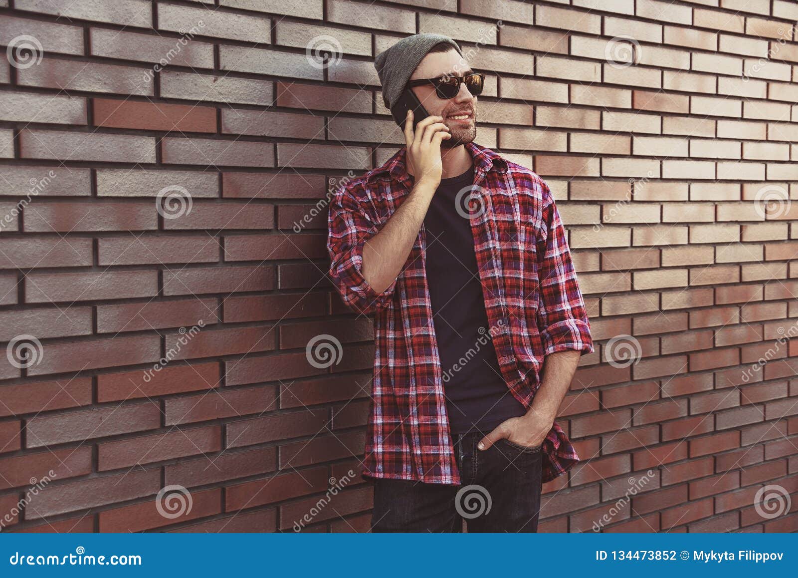 Side View Of Handsome Young Man In Smart Casual Wear Talking By Mobile Phone At The Brick Wall Background Stock Photo Image Of Happy Business 134473852