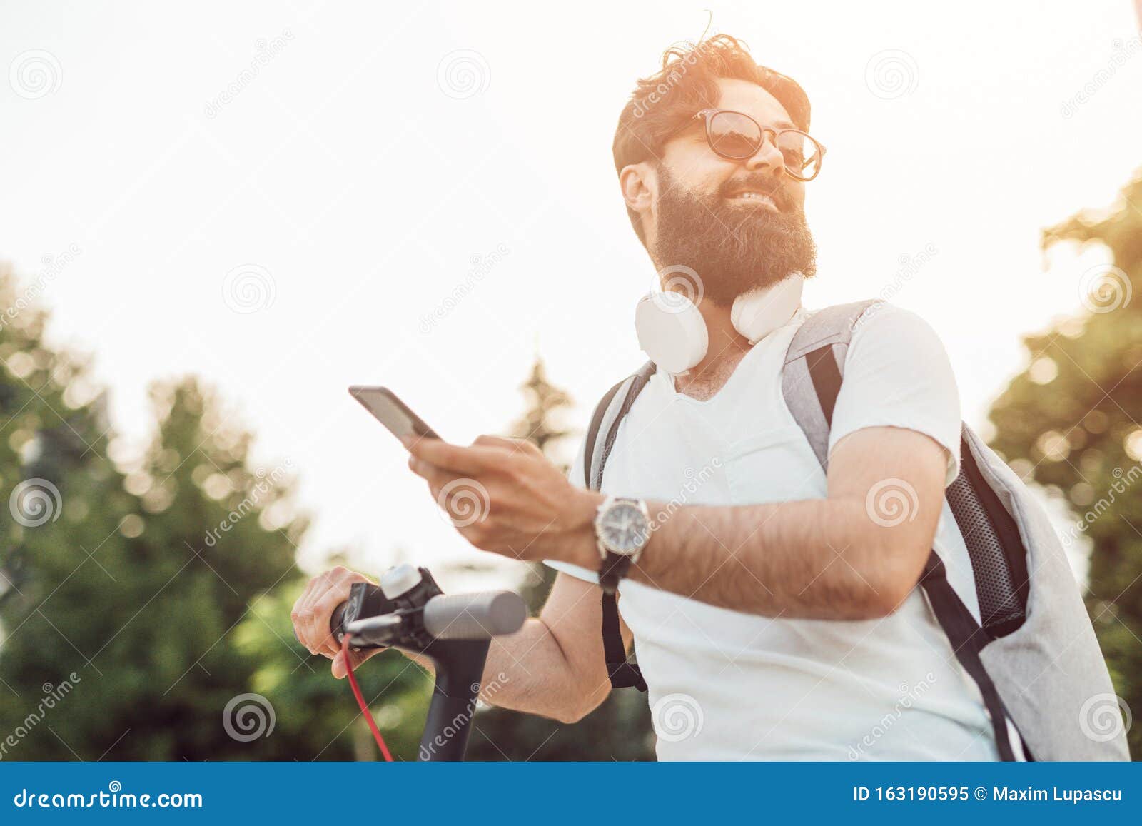 Hipster with Smartphone Riding Eco Vehicle Stock Image - Image of