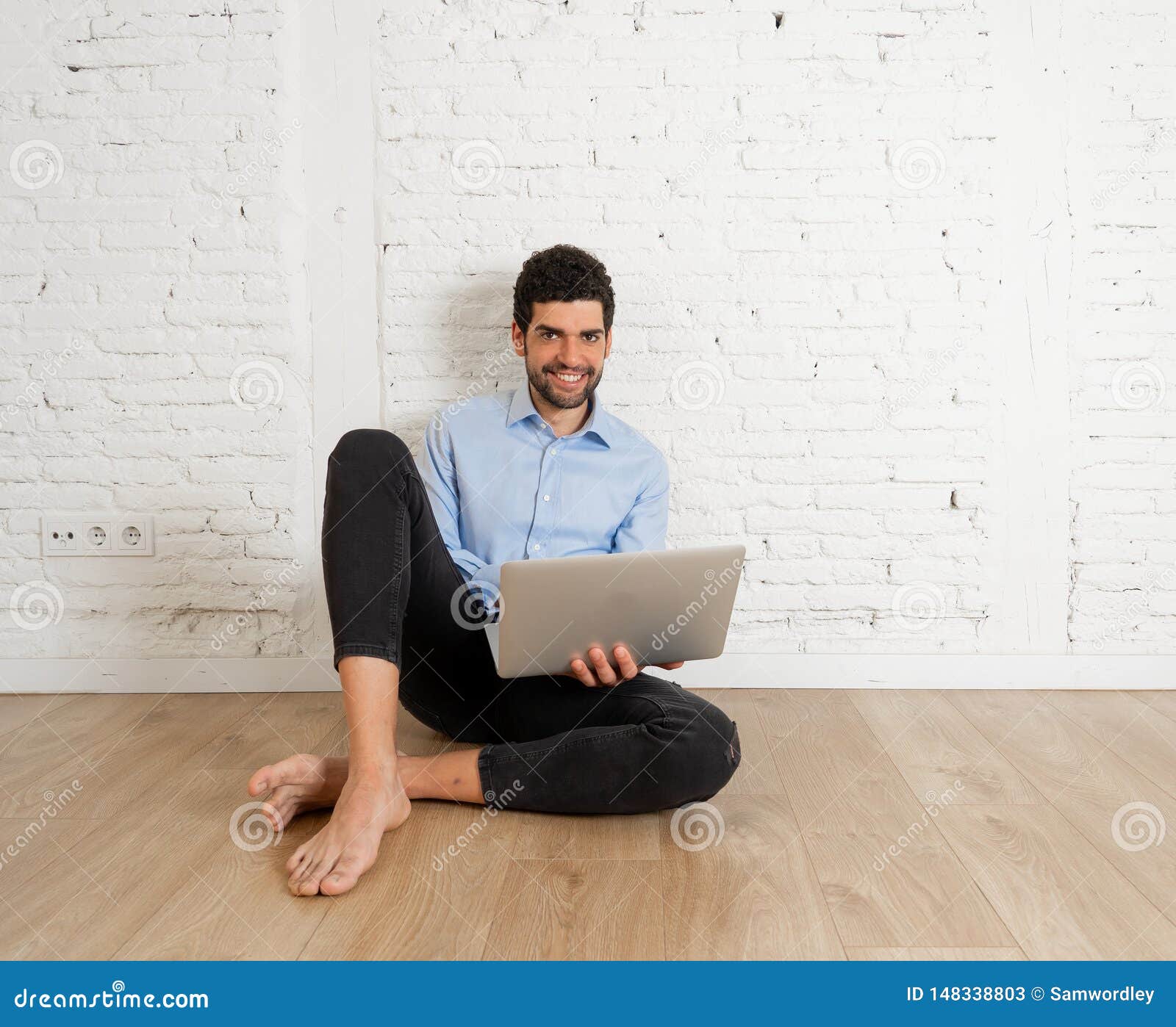 Hipster Young Man on Laptop in His New Empty Apartment Searching on the ...