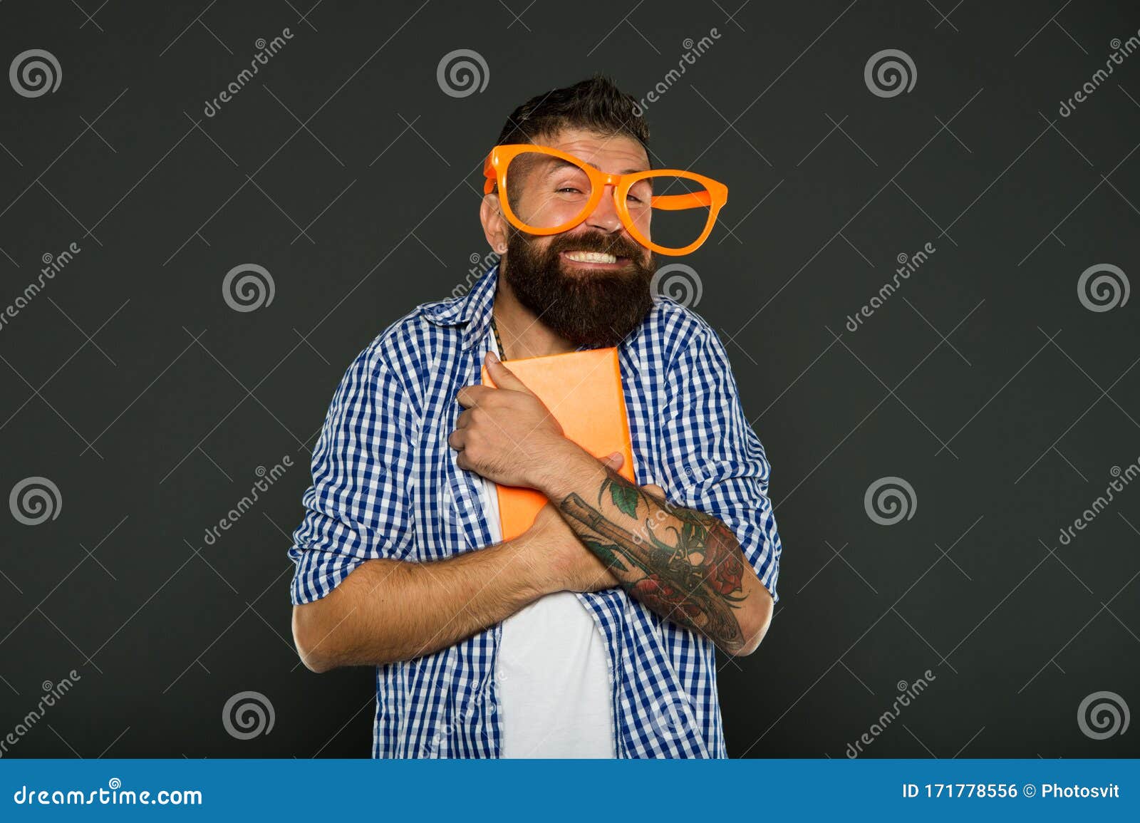 His favorite book. Bearded man in party glasses with lesson book. Book nerd wearing fancy glasses. University male student with lecture notes. Study nerd holding book.