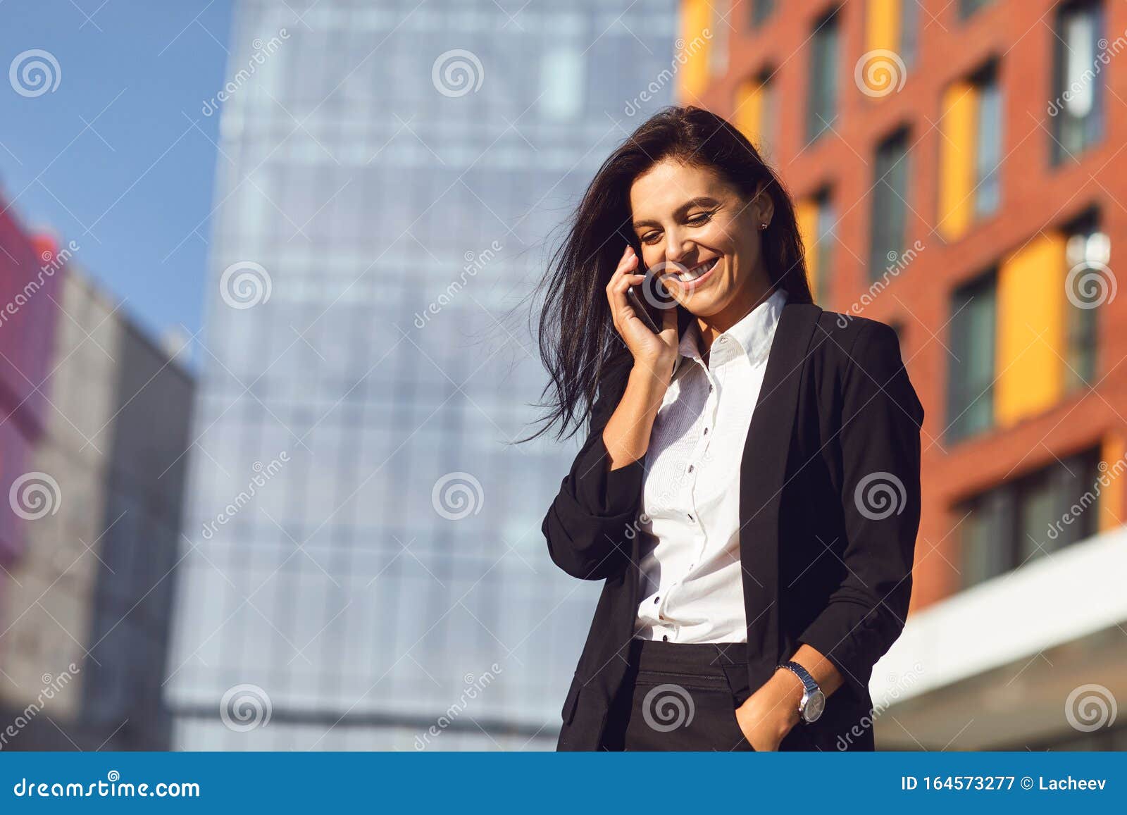 Hispanic Businesswoman Smiling Speaks on a Mobile Outdoors Stock Image ...