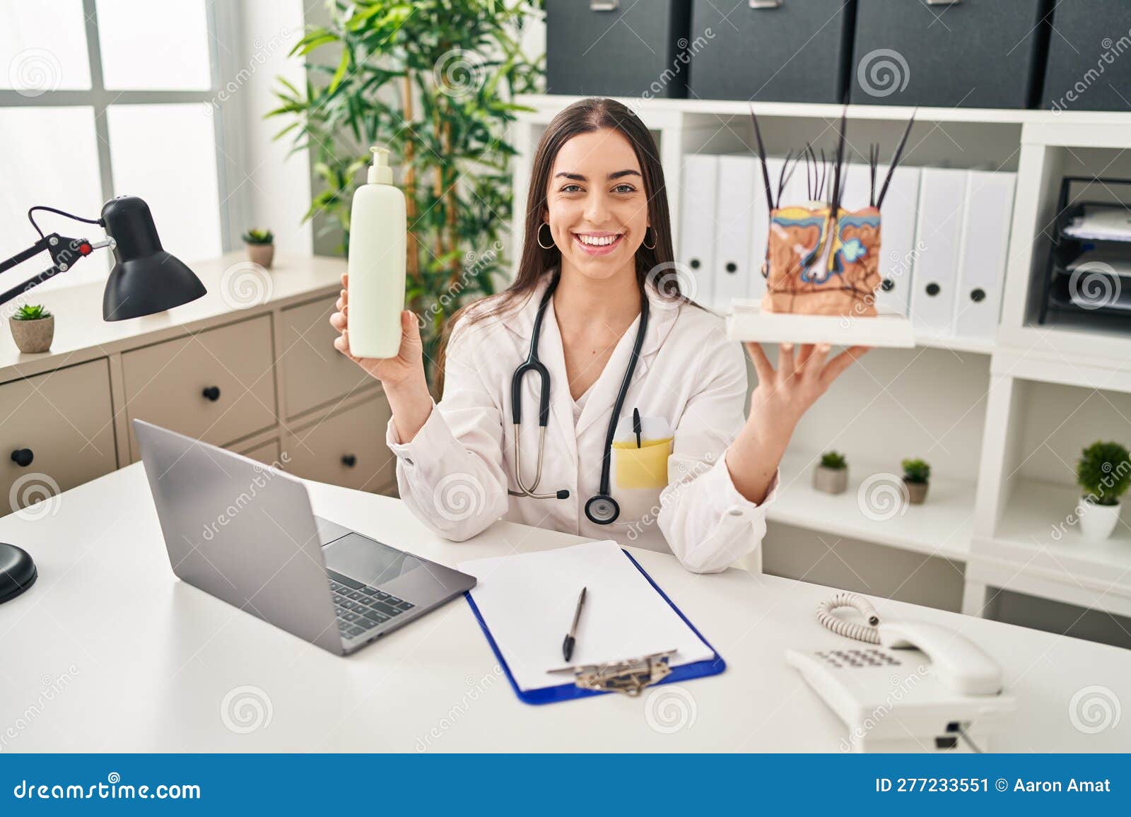 hispanic doctor woman holding model of human anatomical skin and hair smiling with a happy and cool smile on face