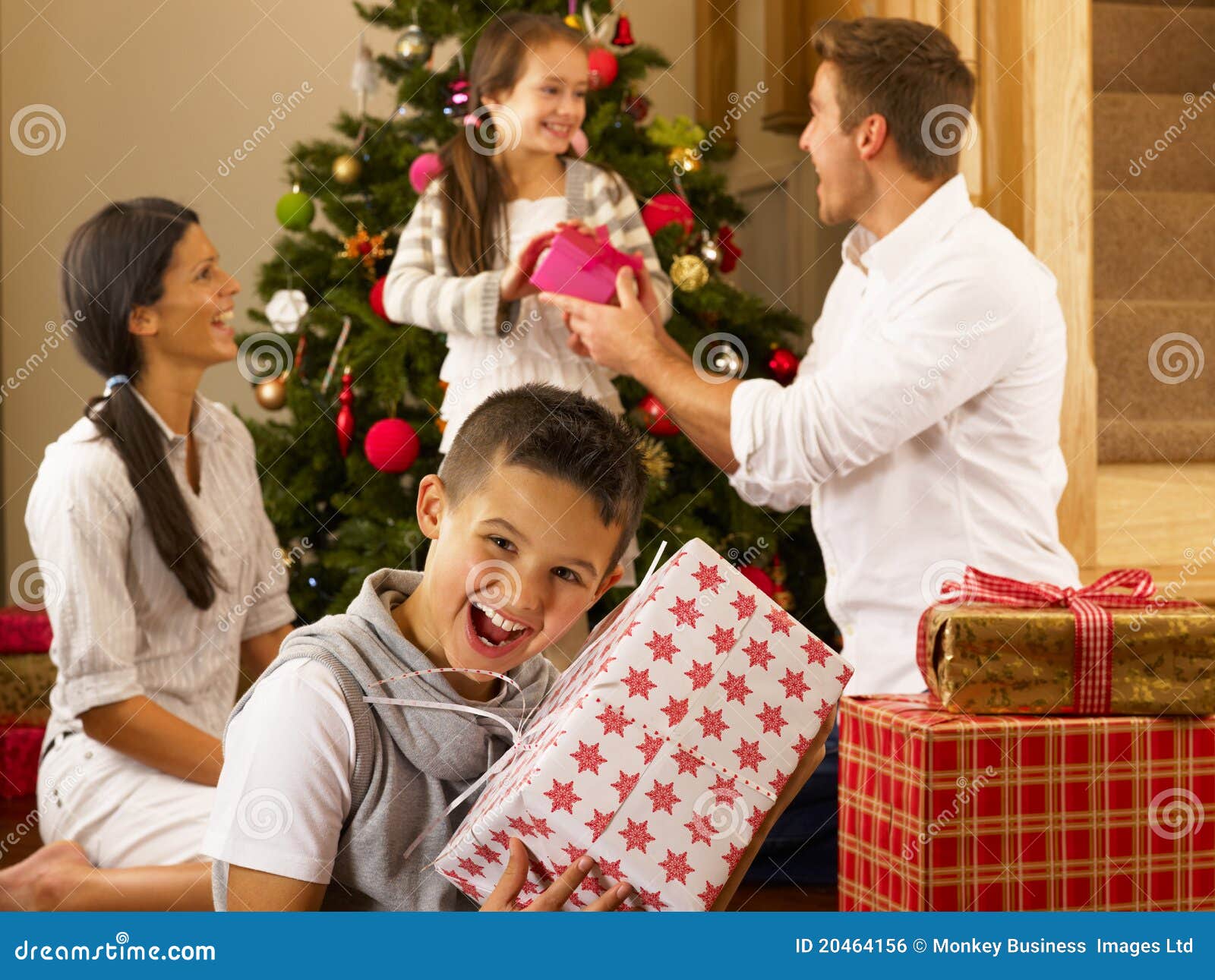 hispanic family exchanging gifts at christmas