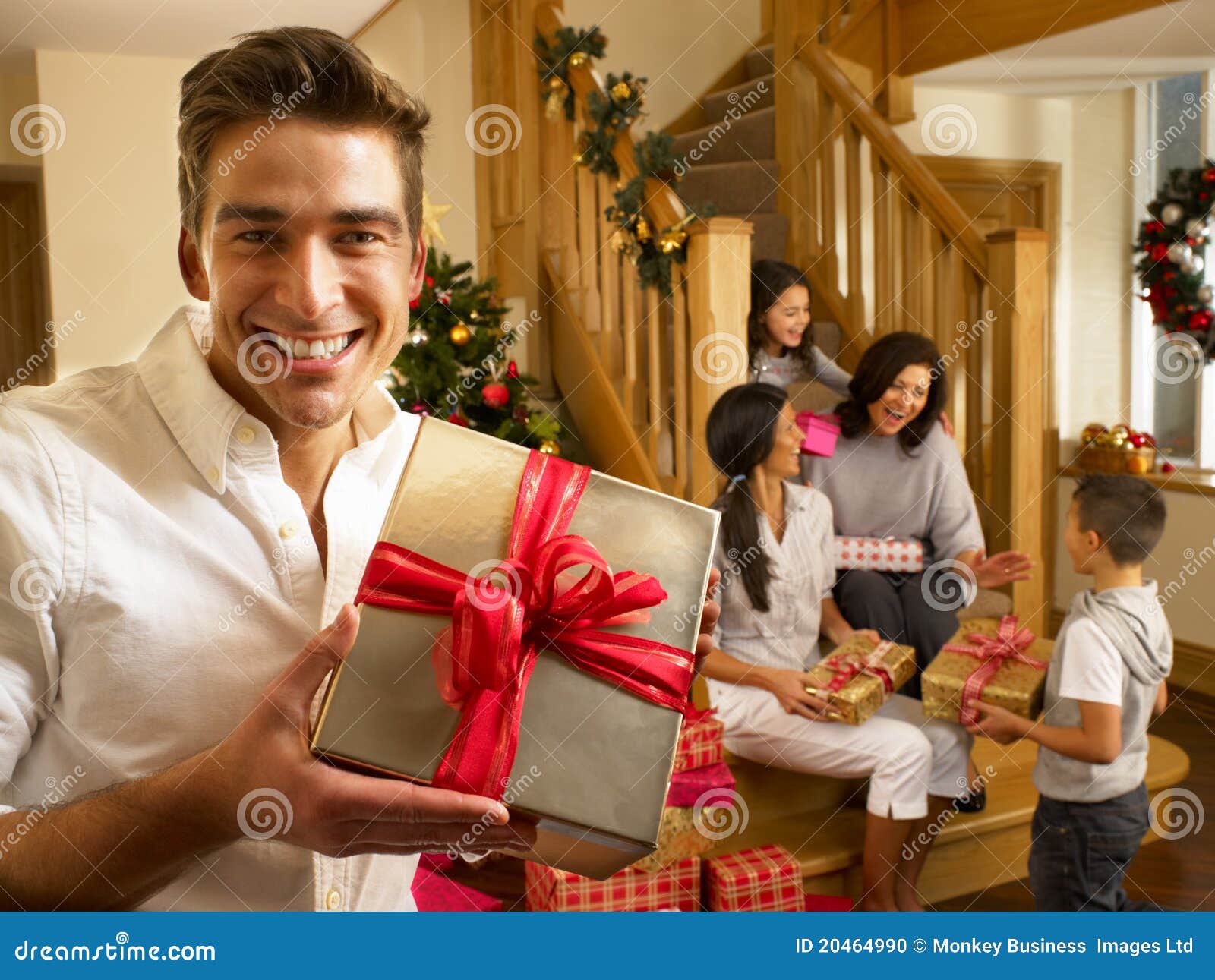 hispanic family exchanging gifts at christmas