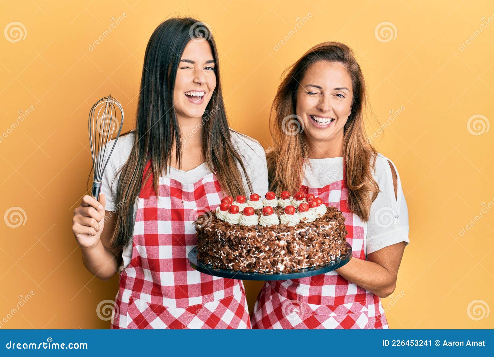 Waitress serving birthday cake to mother and daughter - Stock Image -  F033/5627 - Science Photo Library