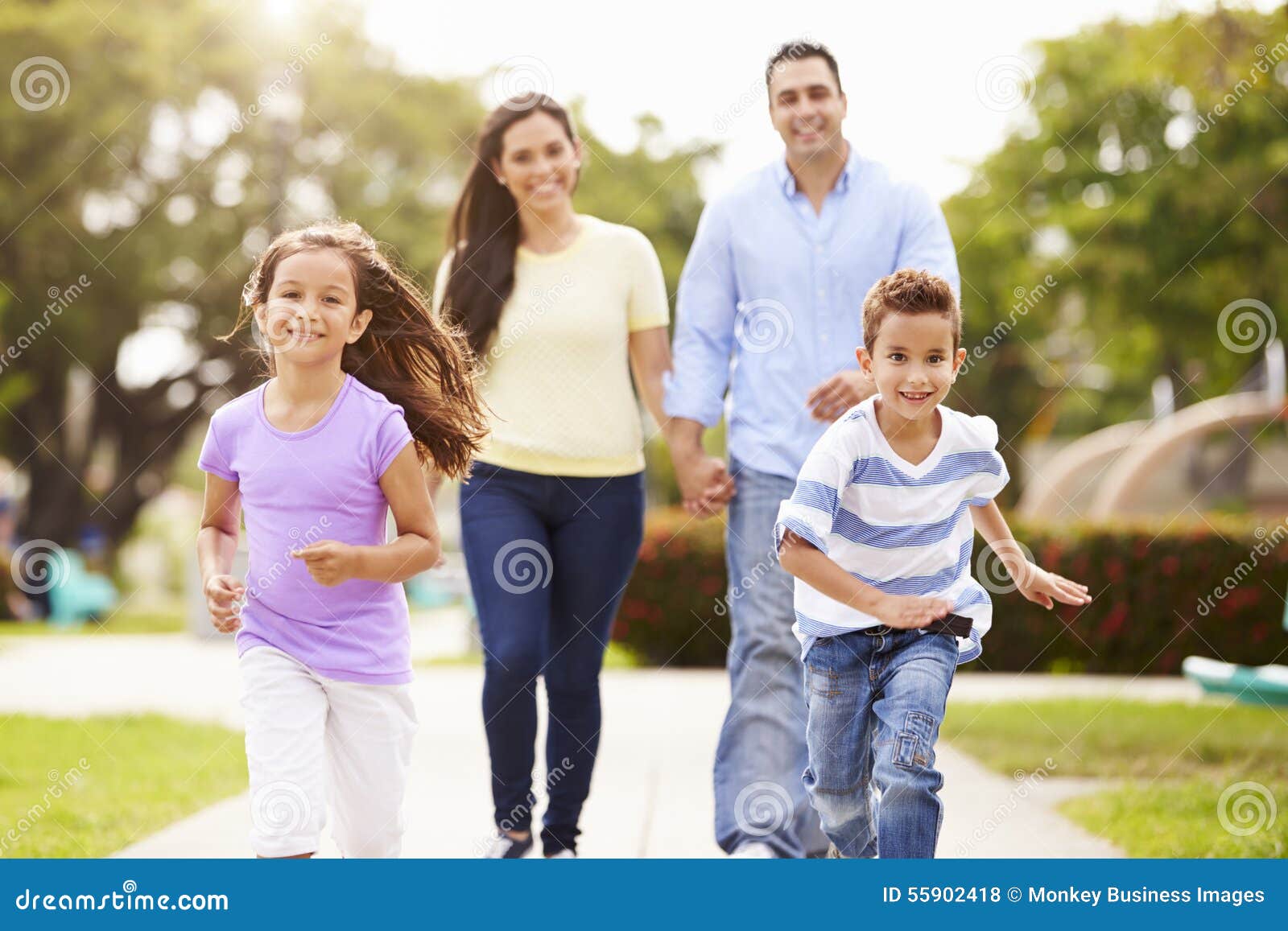 hispanic family walking in park together