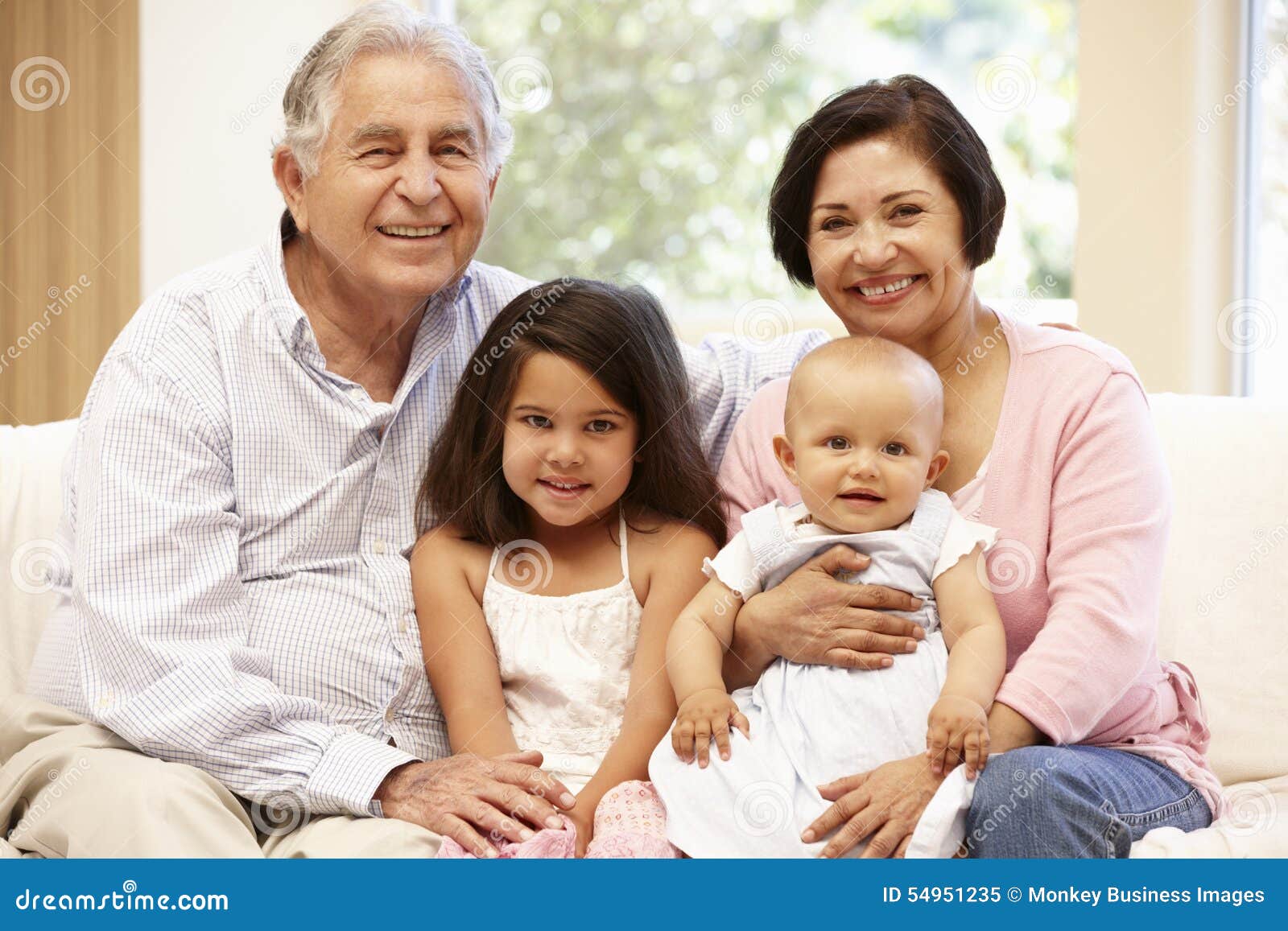 hispanic grandparents at home with grandchildren