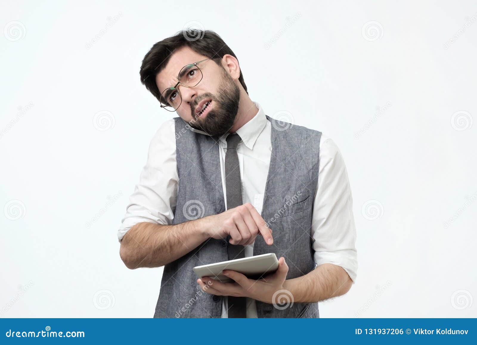 Hispanic Guy With Beard Talking On A Mobile Phone Trying To Find