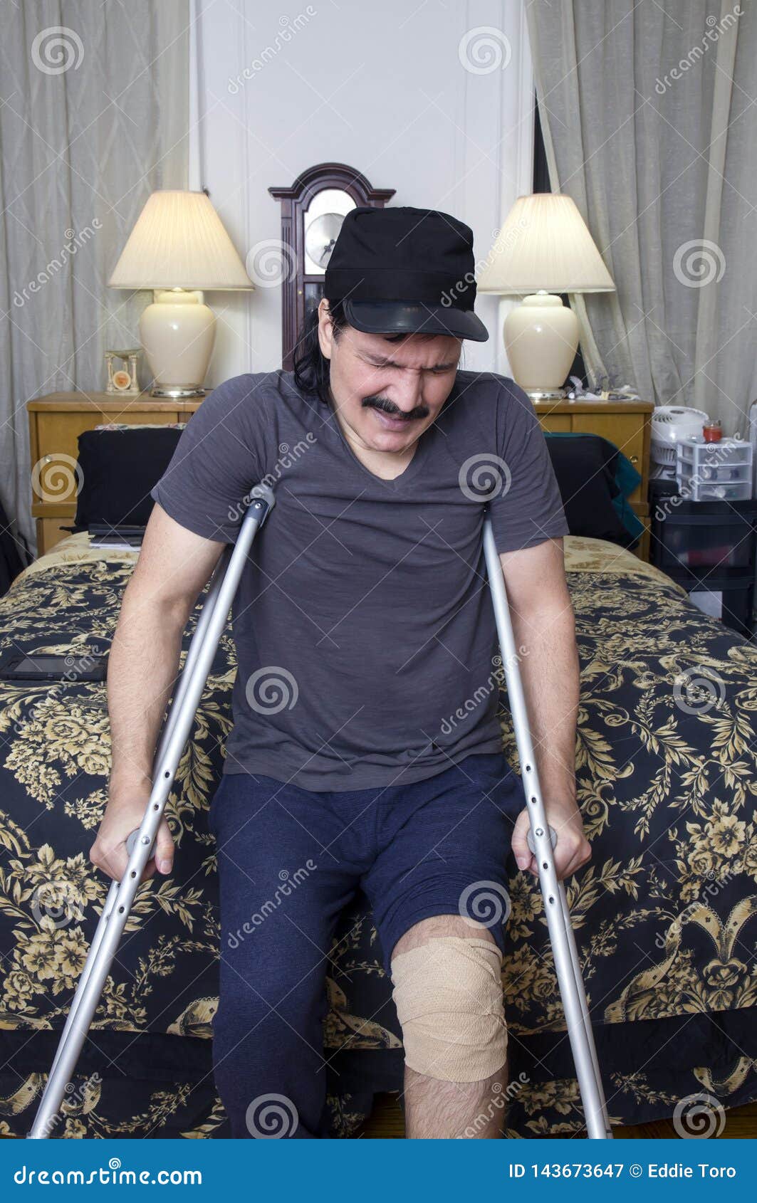 Hispanic Man with Crutches and Expression of Pain Stock Image Image