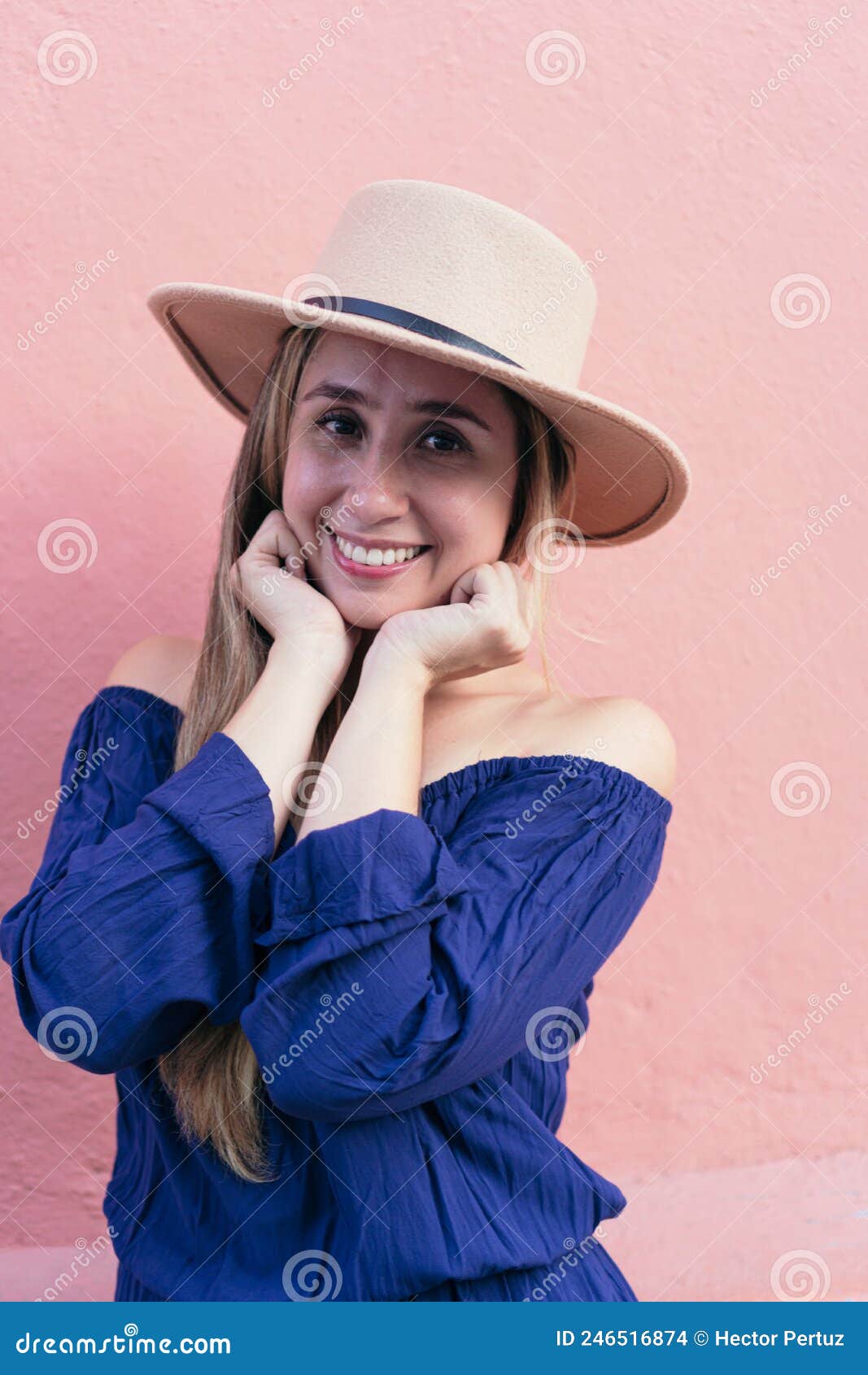 Hispanic Man Posing On Cyclone Fence Stock Photo