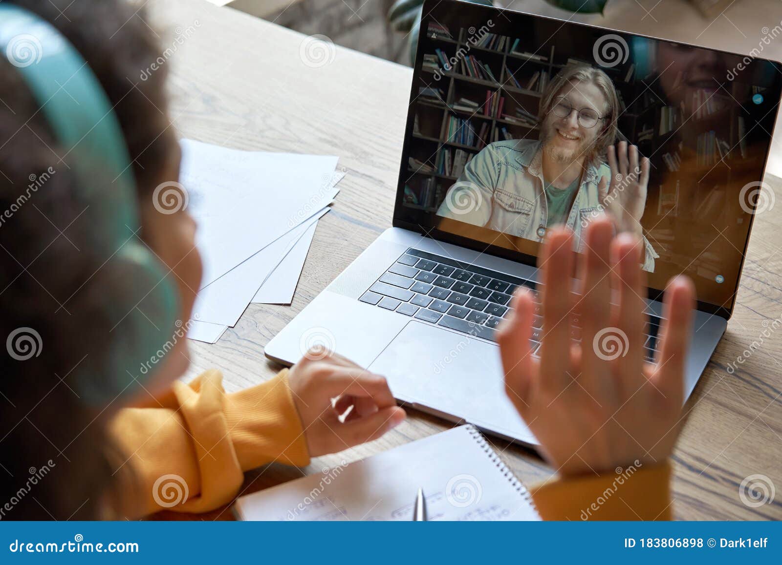 hispanic teen girl distance learning with online teacher on laptop screen.
