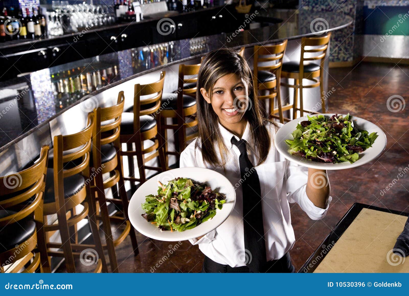 hispanic waitress serving salads