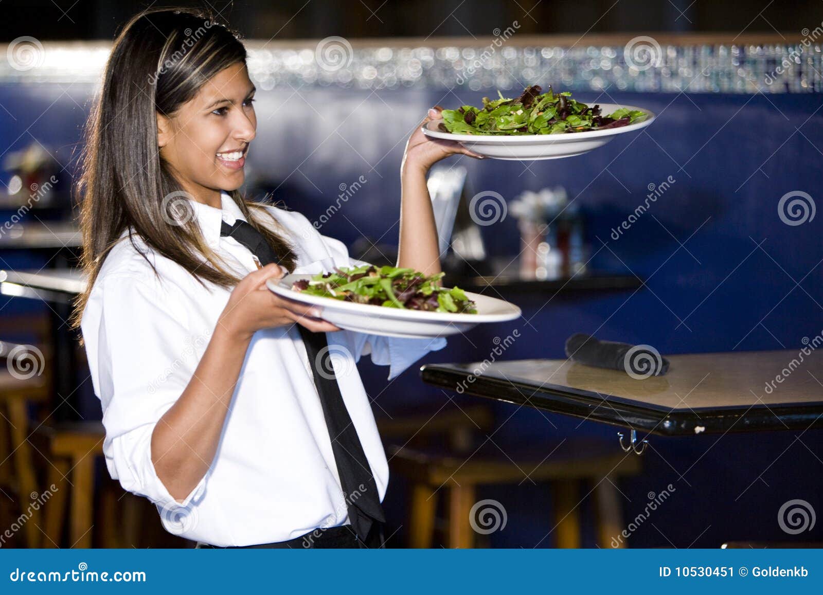 hispanic waitress serving salads