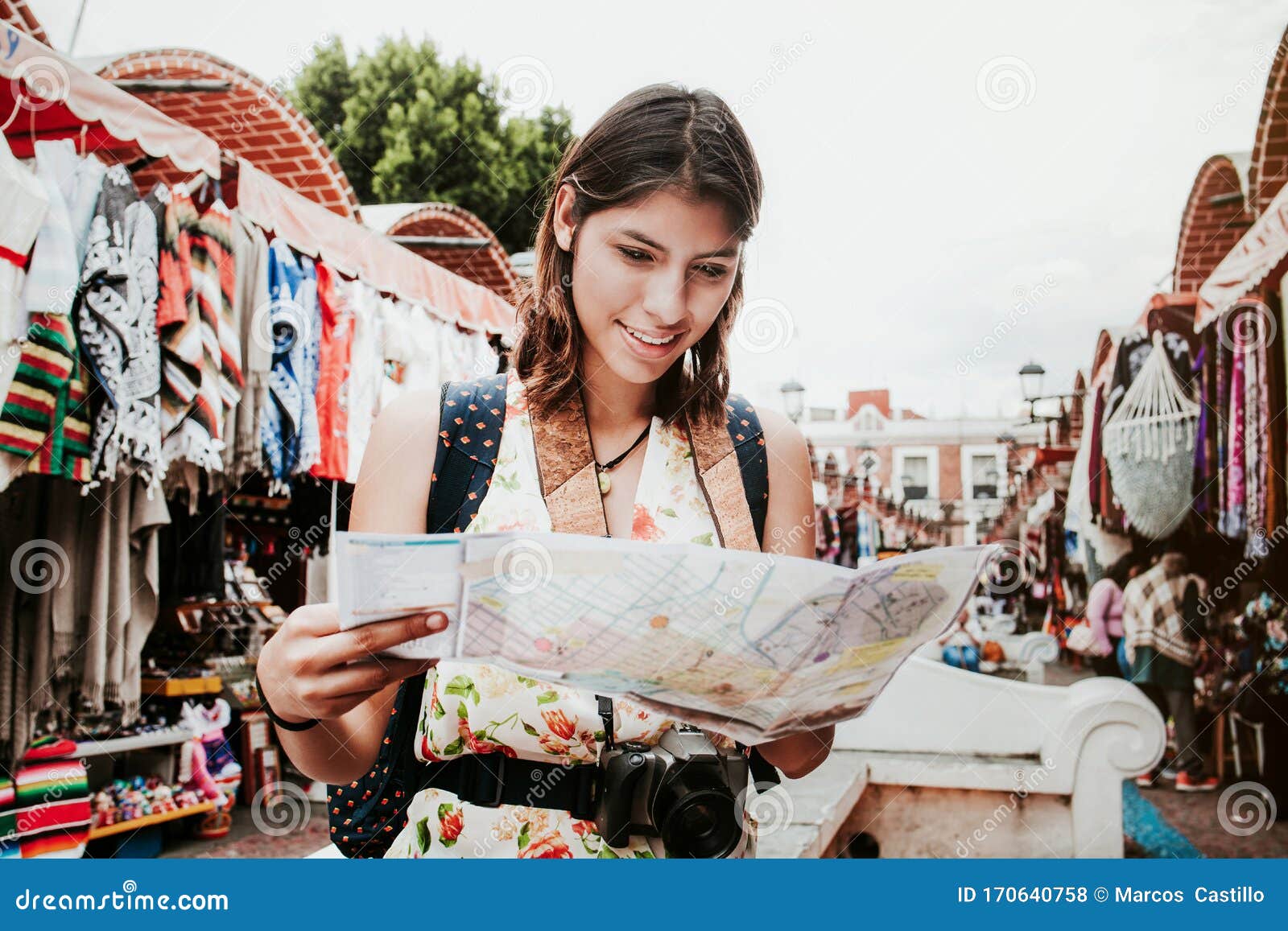 Hispanic Woman Backpacker Holding a Map and Camera in a Traditional ...