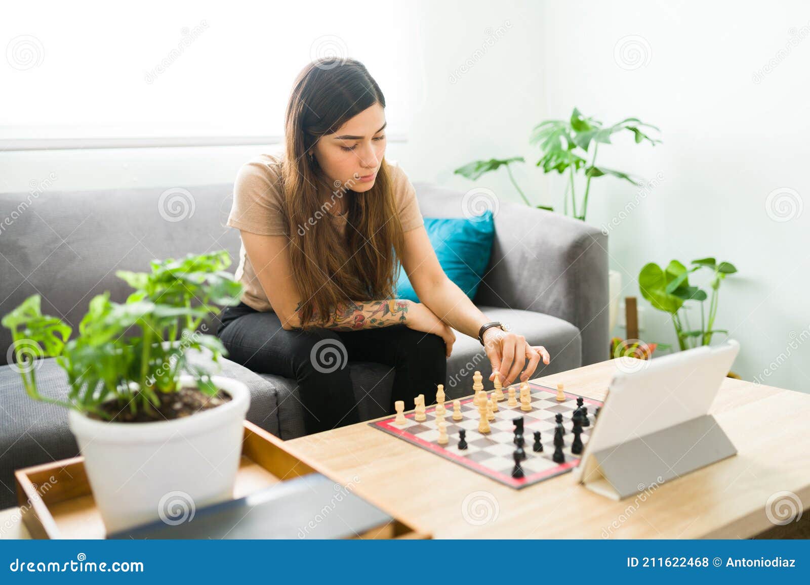 Premium Photo  Woman playing chess online uses laptop