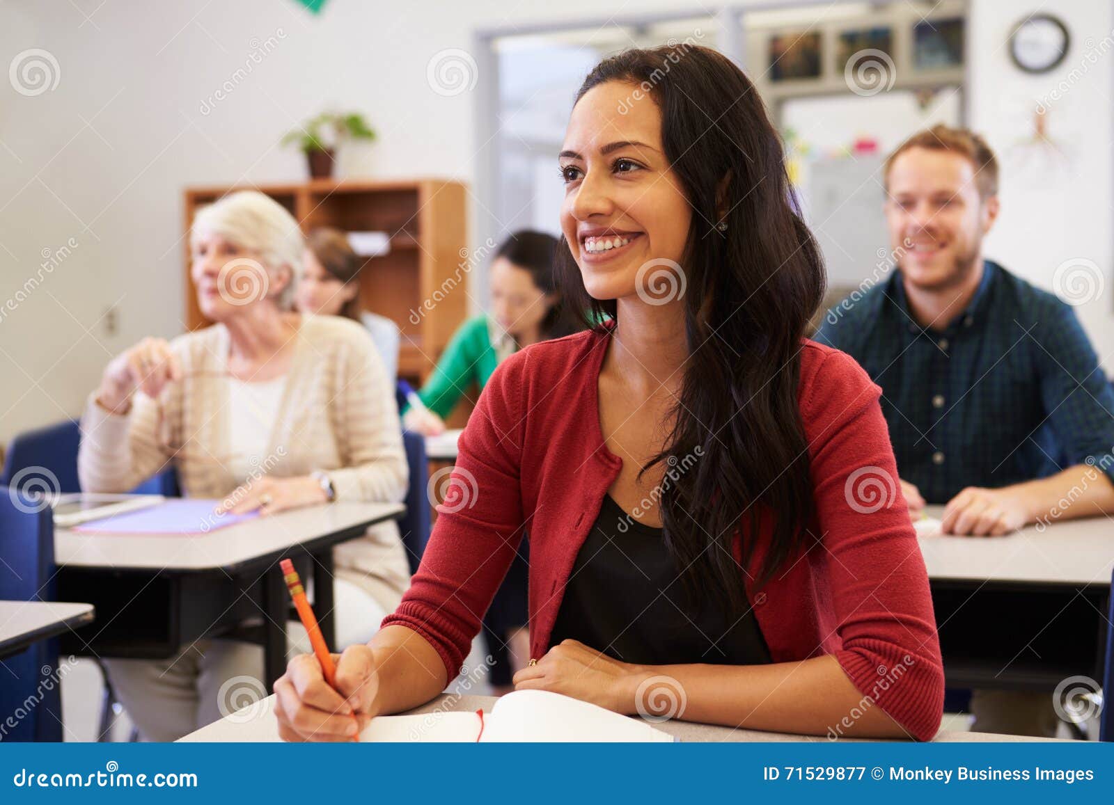 hispanic woman studying at adult education class looking up