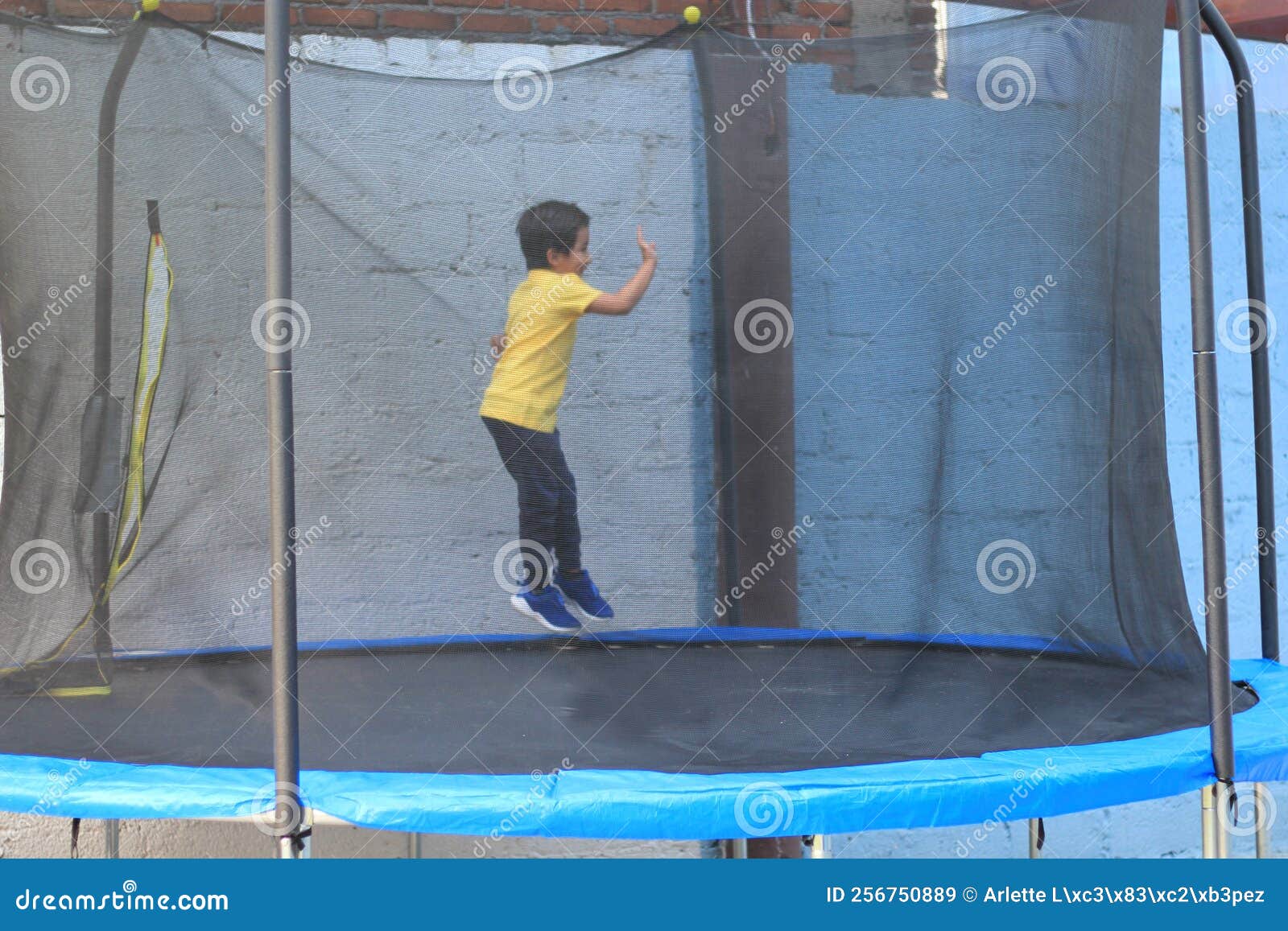 hispanic 6-year-old boy jumping on a brincolin as a physical activity for a healthy life he exercises and has fun alone at home