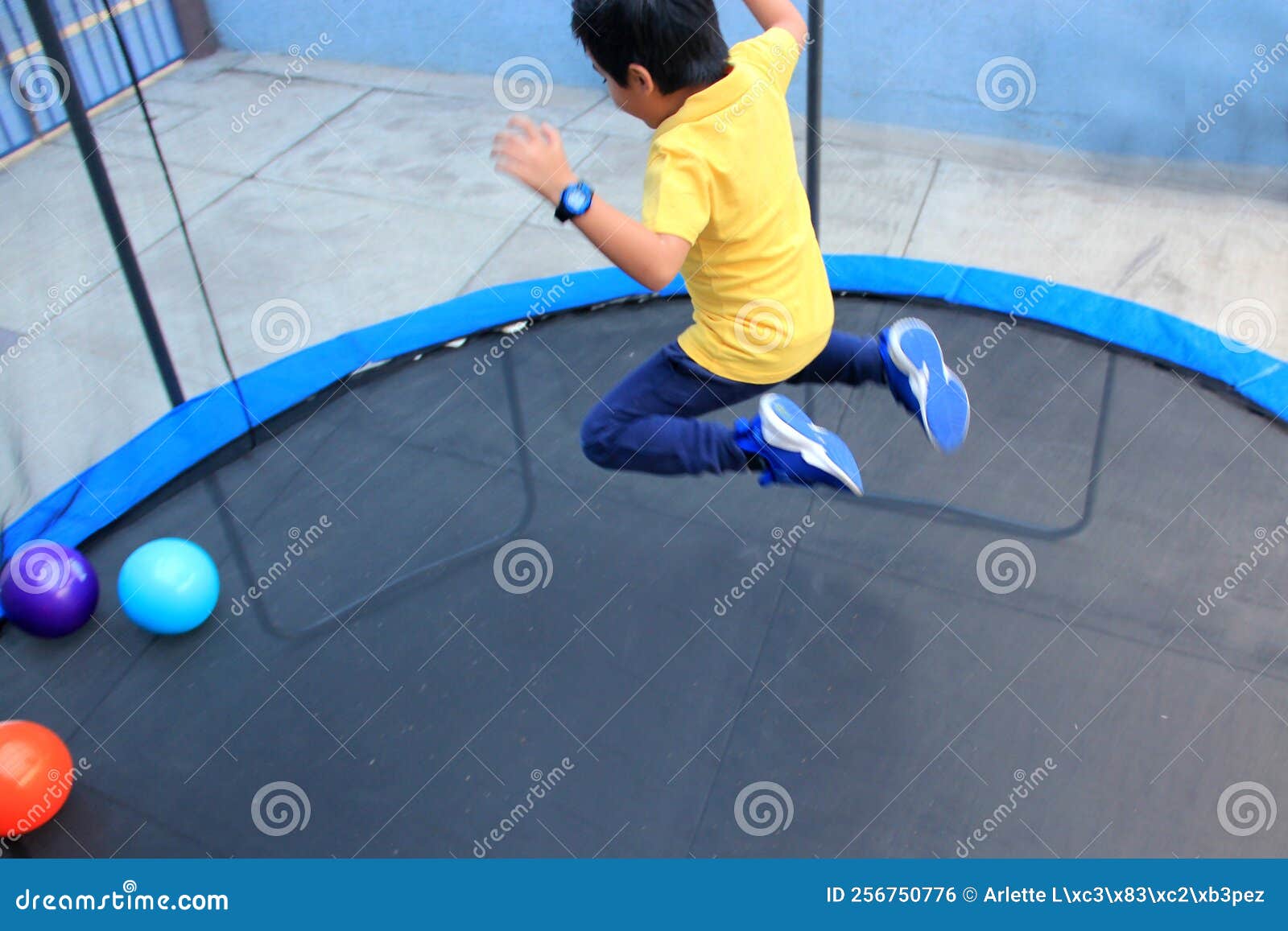 hispanic 6-year-old boy jumping on a brincolin as a physical activity for a healthy life he exercises and has fun alone at home