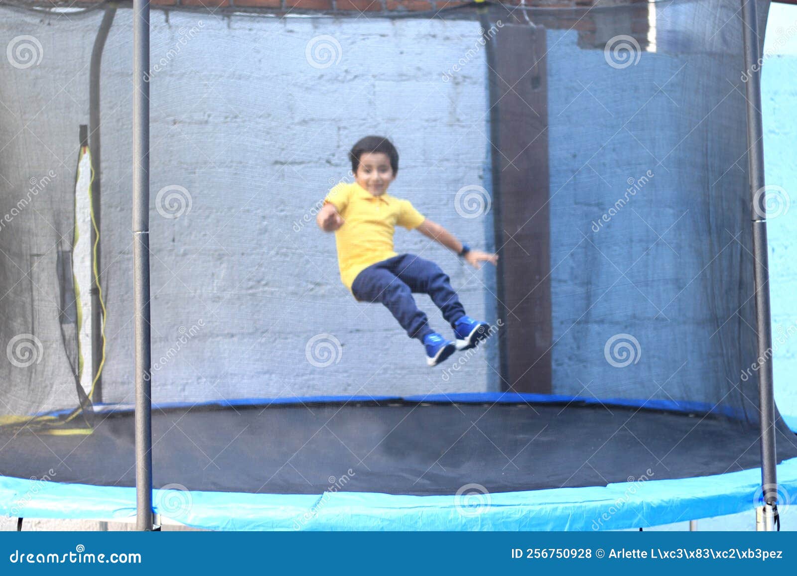 hispanic 6-year-old boy jumping on a brincolin as a physical activity for a healthy life he exercises and has fun alone at home