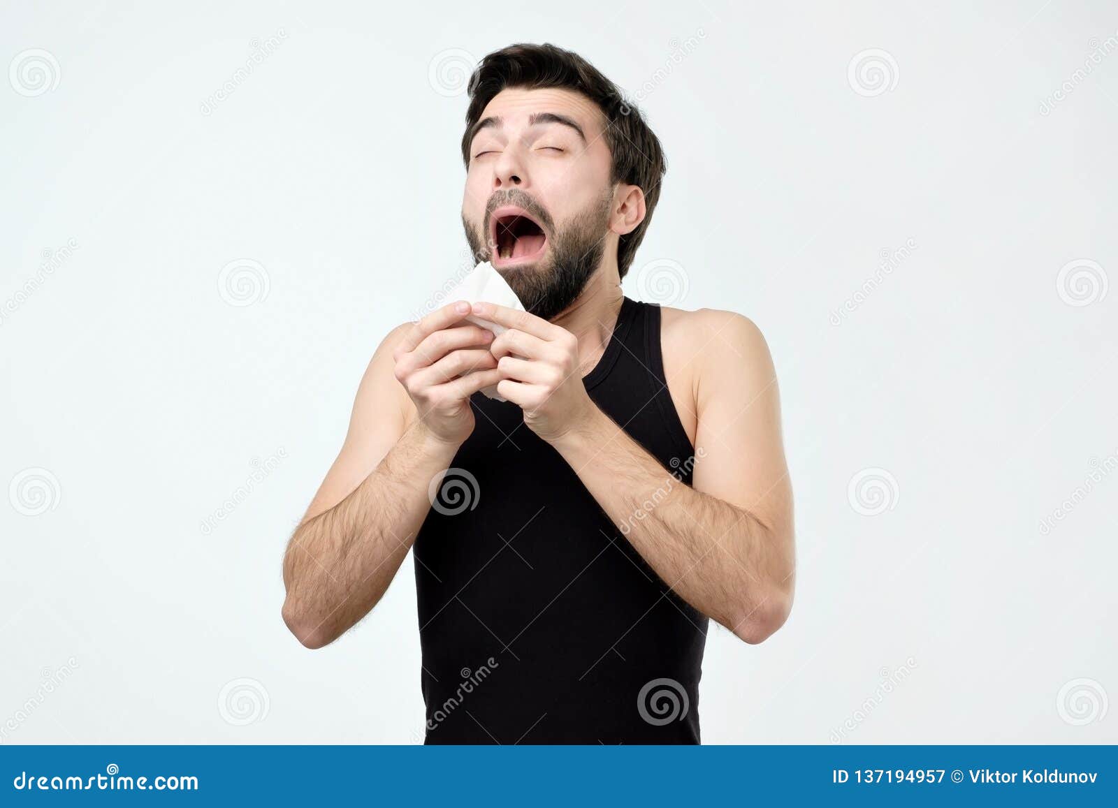 Hispanic Young Man with Black Beard Being Ill Sneezing Stock Image