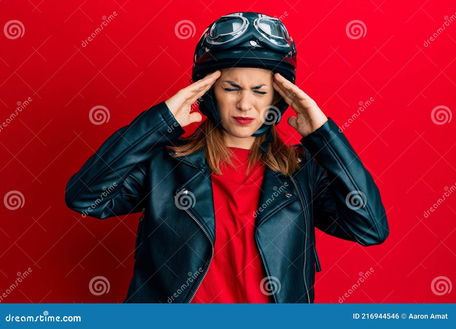 Hispanic Young Woman Wearing Motorcycle Helmet Suffering from Headache