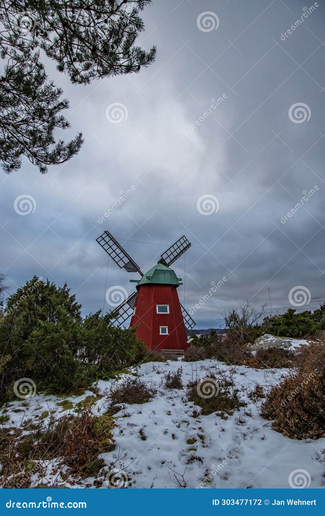 historical windmill made of red wood in a winter landscape.stenungsund in sweden