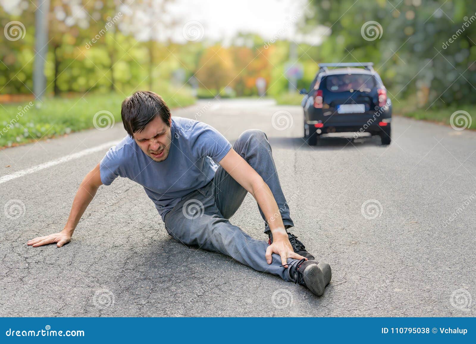 hit and run concept. injured man on road in front of a car