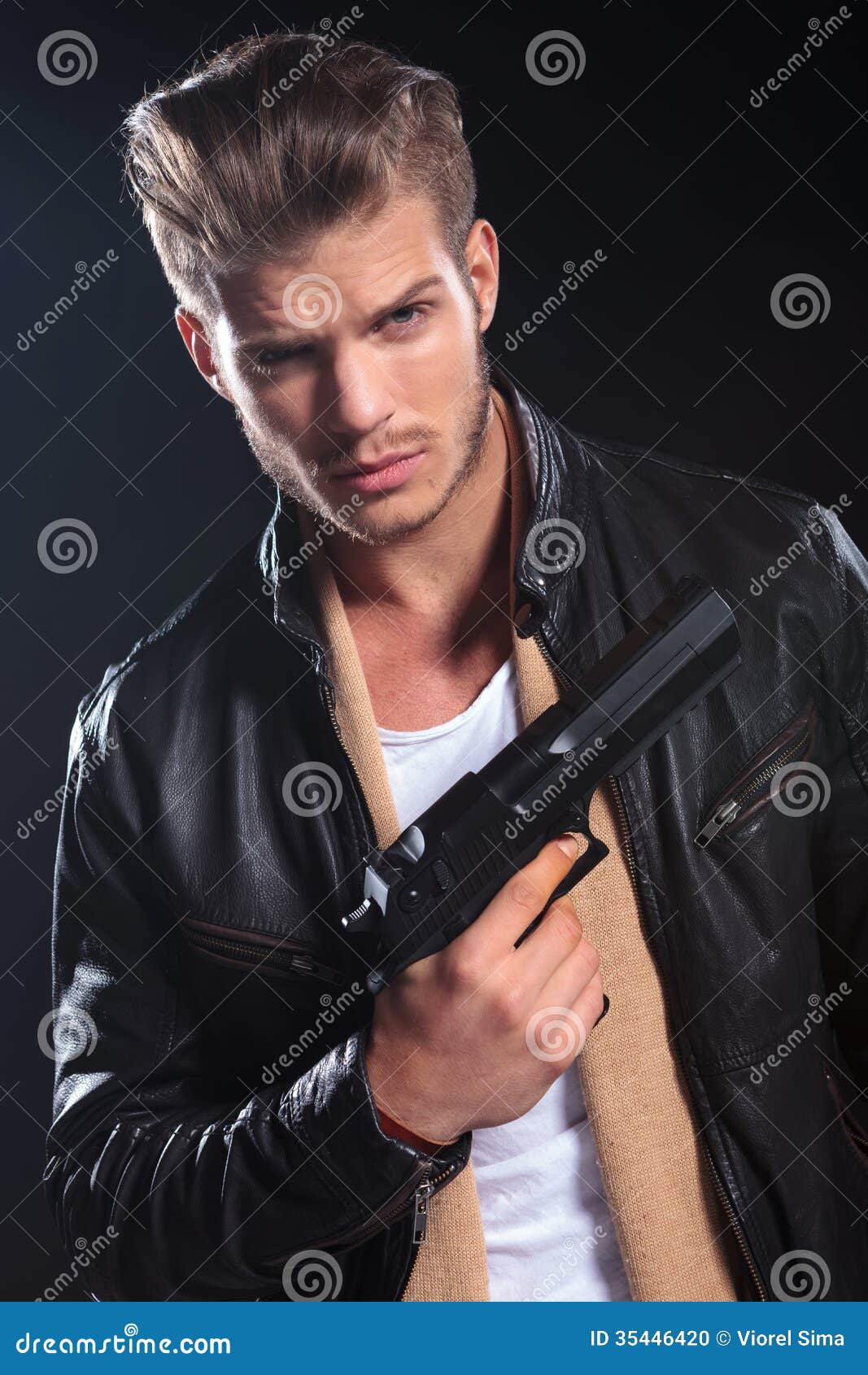 Hitman In Leather Clothes Holding A Big Gun In His Hand 