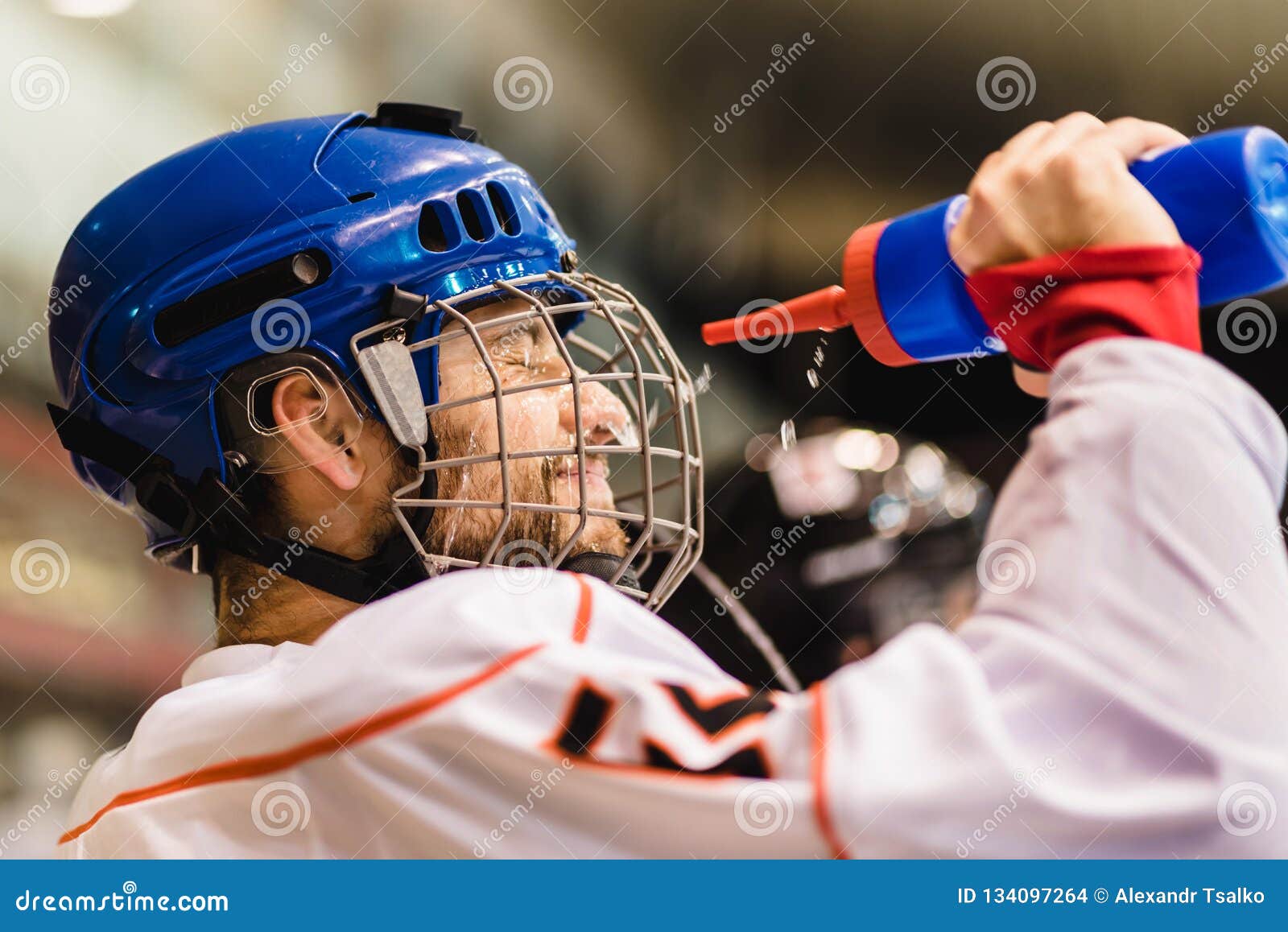 Hockey Player Drinks from a Bottle and Then Pours Water Over His Face Stock  Photo - Image of prepare, player: 134097264