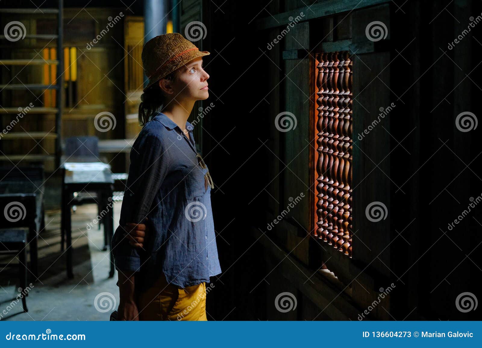hoi an / vietnam, 11/11/2017: female tourist standing in the dark wooden interior of a traditional house tan ky in hoi an,
