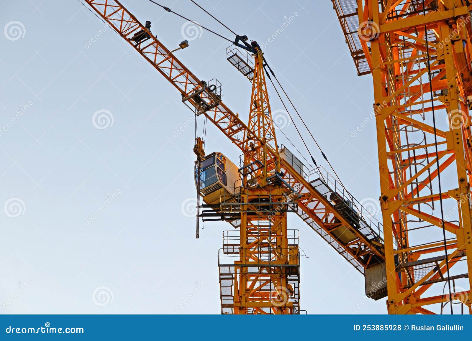 Hoisting Construction Cranes on Background of Building Site