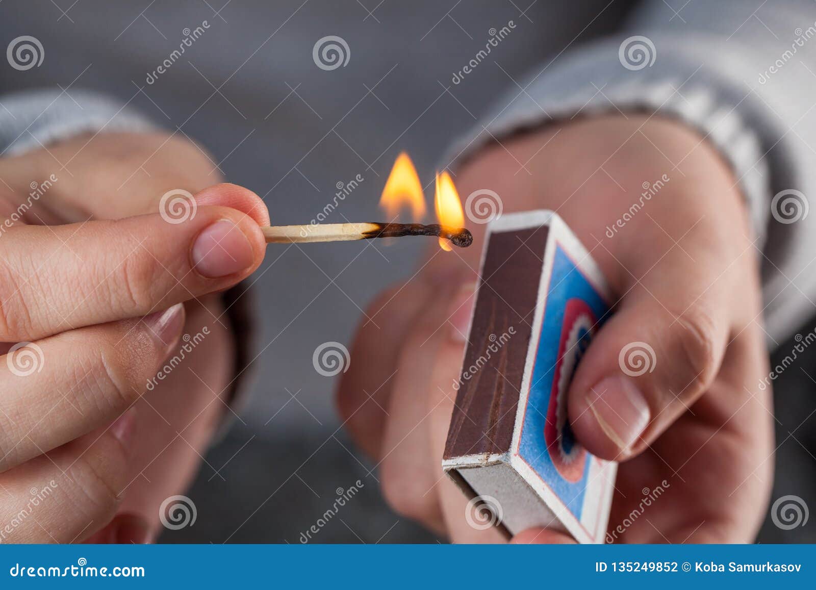 Hold a Matchbox while Striking a Match Stock Photo Image of heat