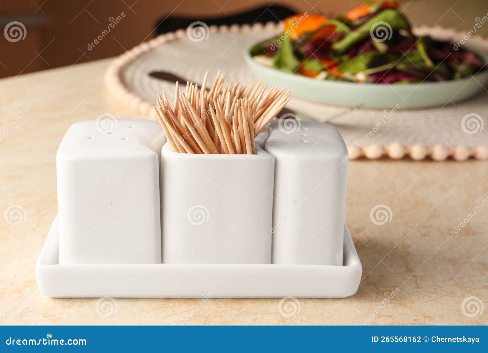 Holder with Salt, Pepper and Toothpicks on Wooden Table Stock Photo