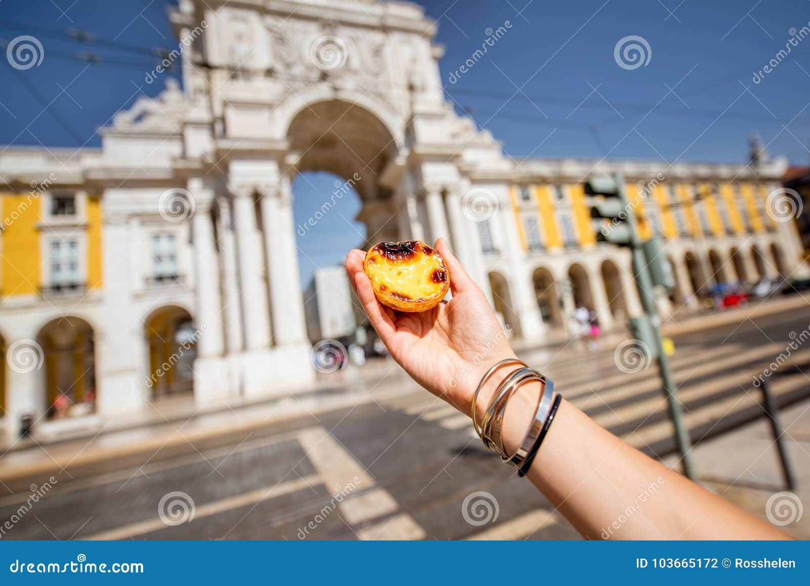 holding pastel de nata cake outdoors