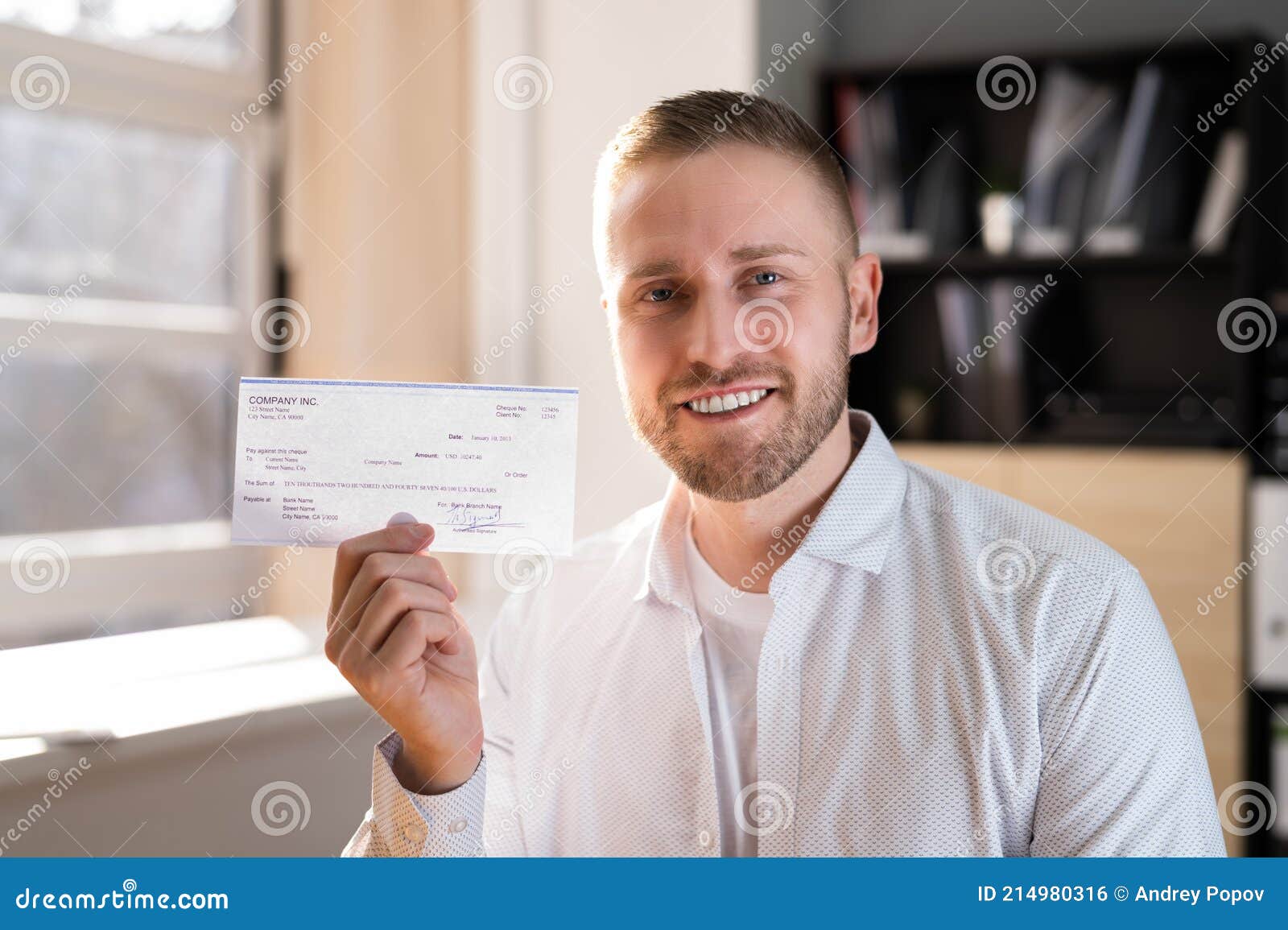 holding paycheck in hand