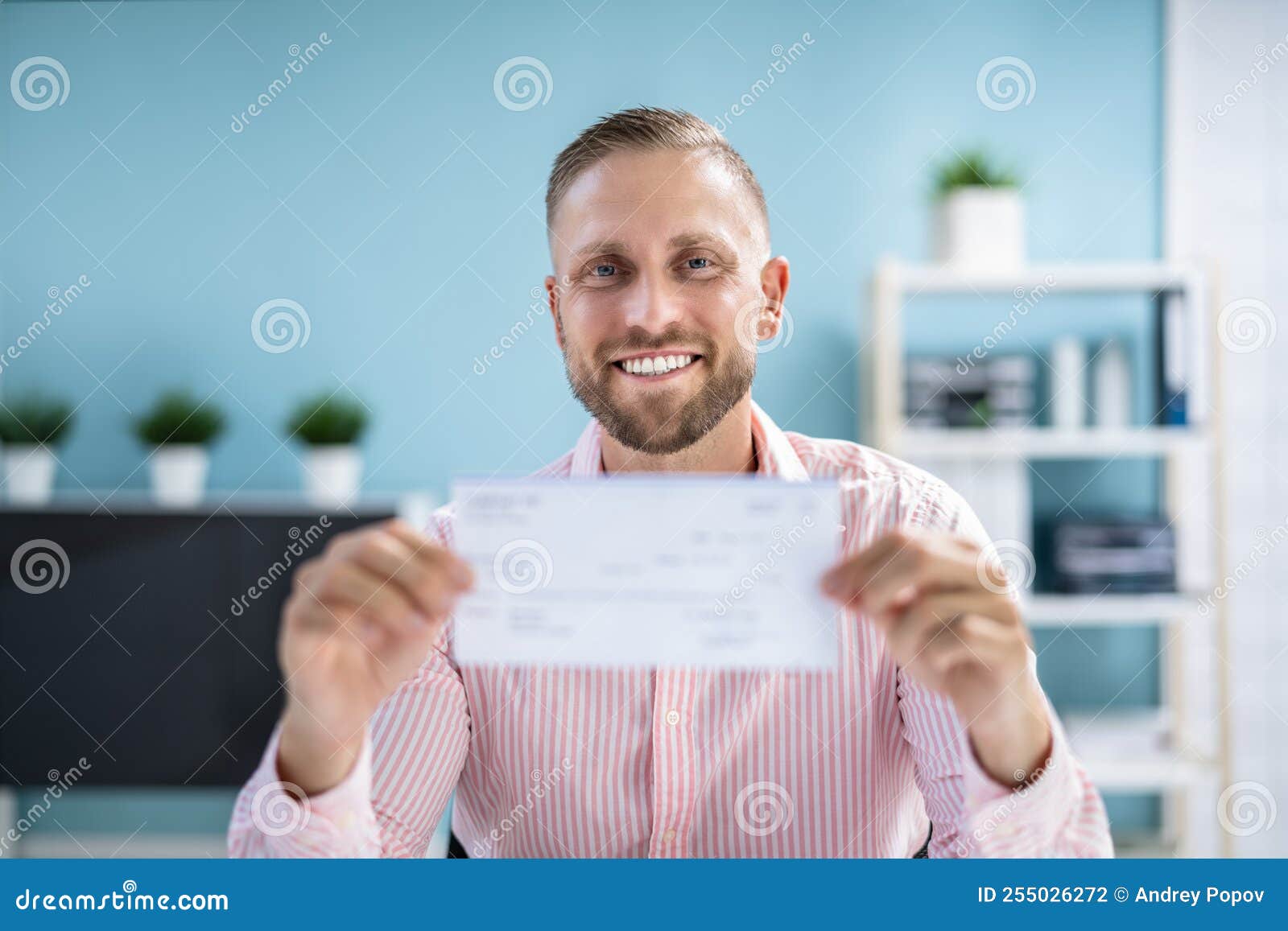 Holding Paycheck or Payroll Check or Insurance Cheque Stock Photo