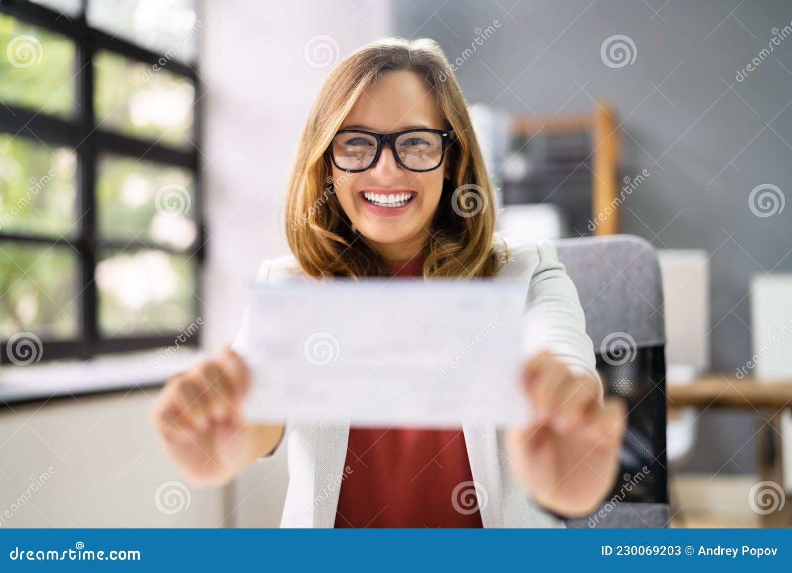Holding Paycheck or Payroll Check or Insurance Cheque Stock Image