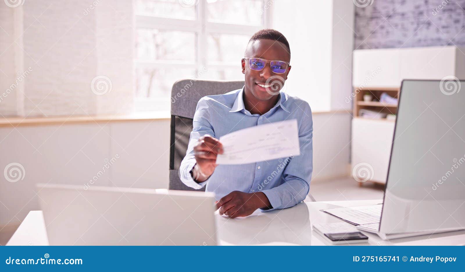 Holding Paycheck or Payroll Check or Insurance Cheque Stock Image