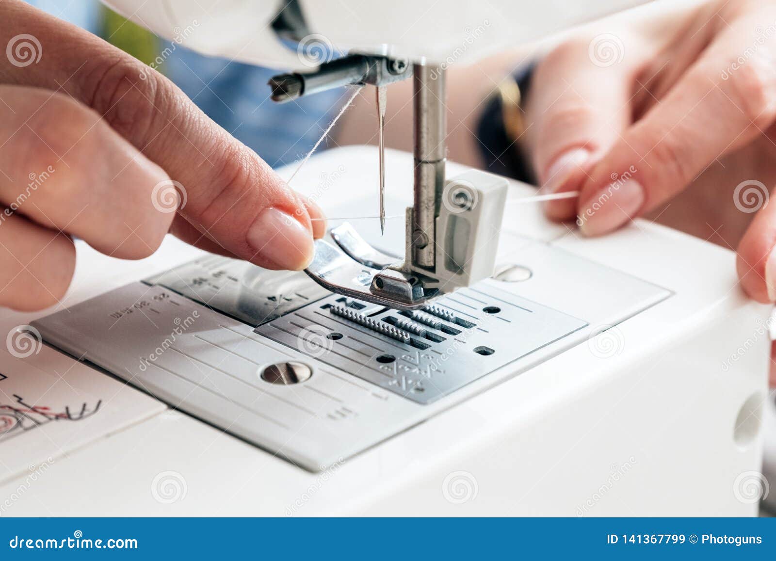 Holding Thread and Threading a Sewing Machine Needle, Close Up View