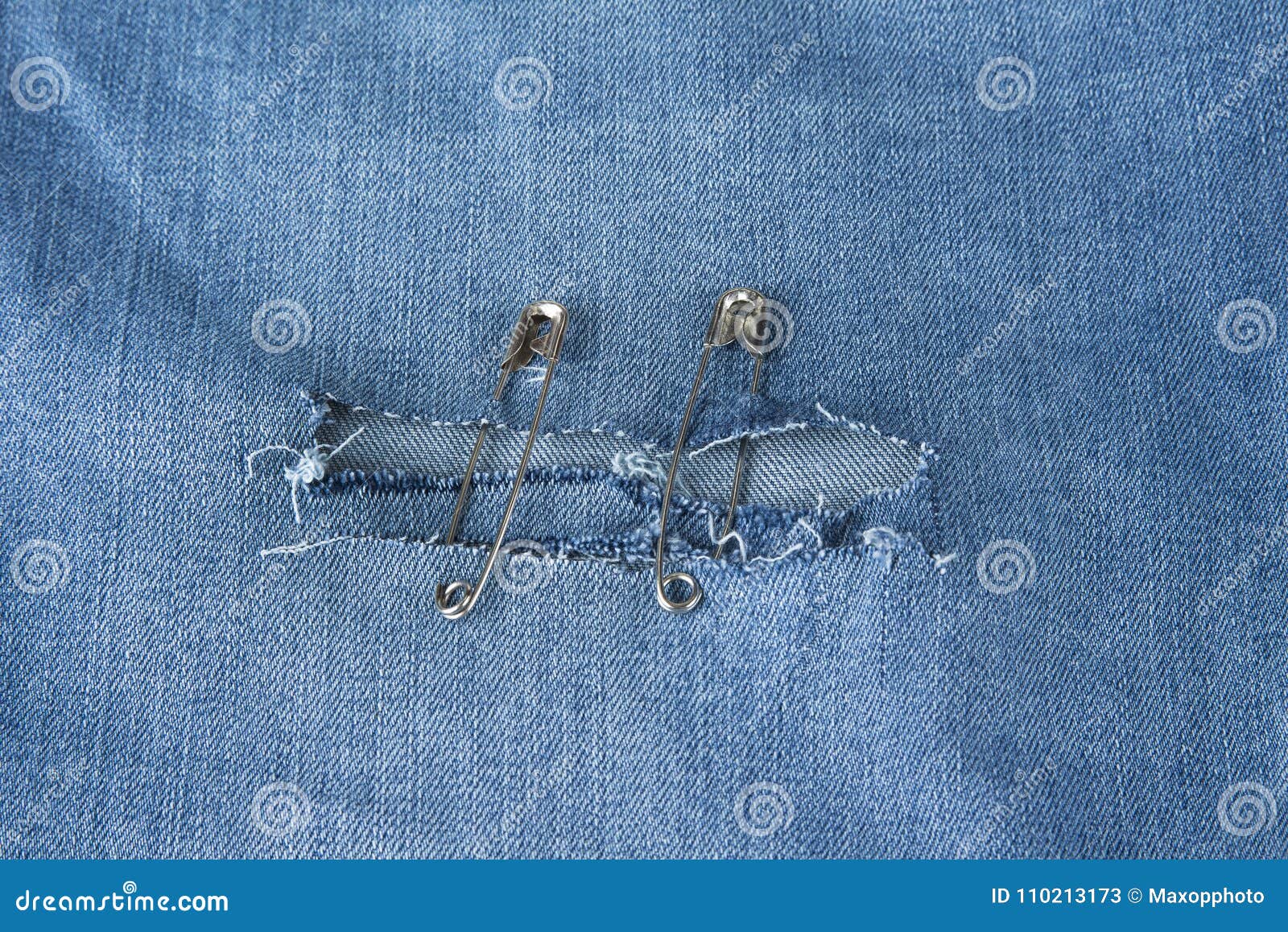 Hole in Blue Jeans Fixed with Safety Pins Stock Image Image of pins