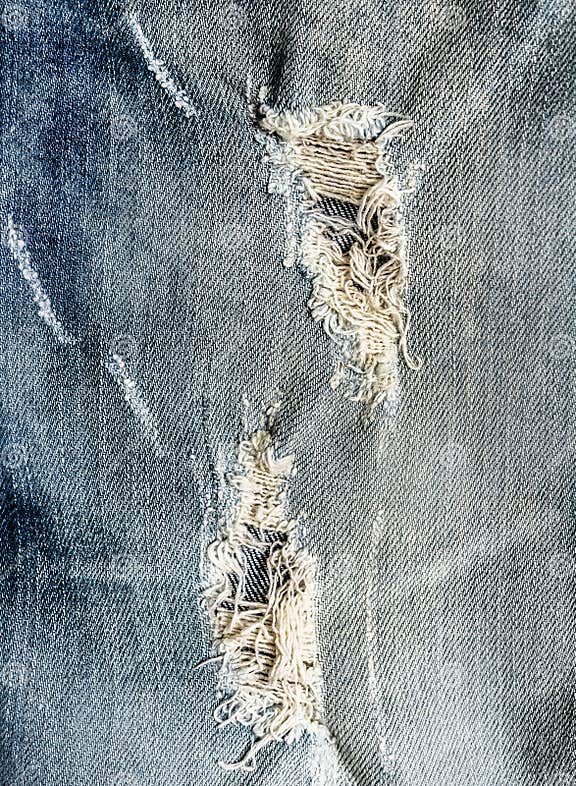 Hole on Denim Jeans . Trendy Frayed Jeans, Ripped Destroyed Torn Blue ...