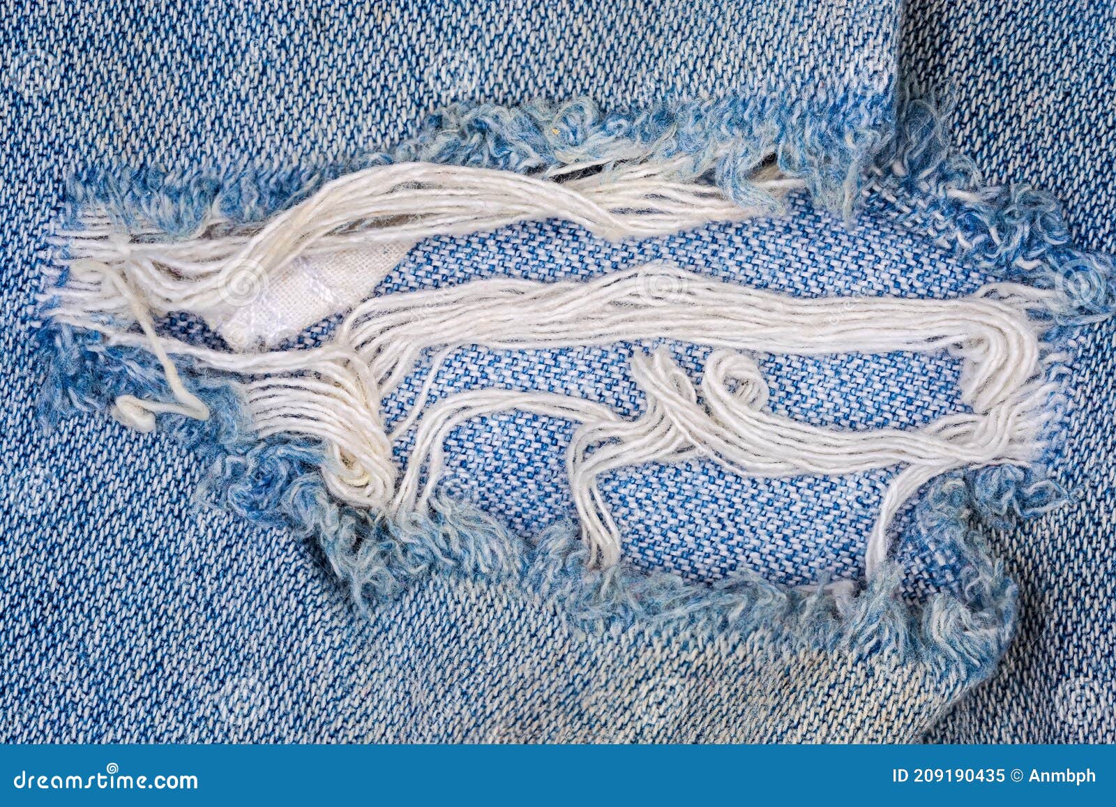 Hole with Frayed Threads in Old Torn Blue Jeans Closeup Stock Image ...