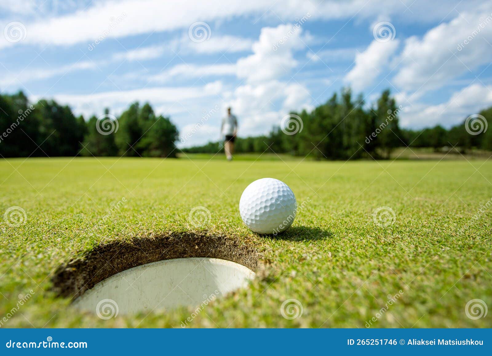 Hole on a Golf Course, Next To a White Ball Stock Photo Image of