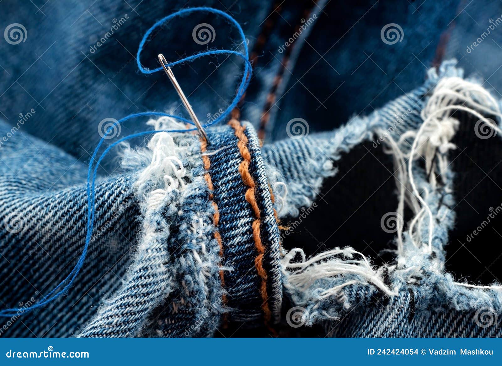 A needle and thread sew up a hole in a denim. Work of a seamstress or  tailor with a needle Stock Photo - Alamy